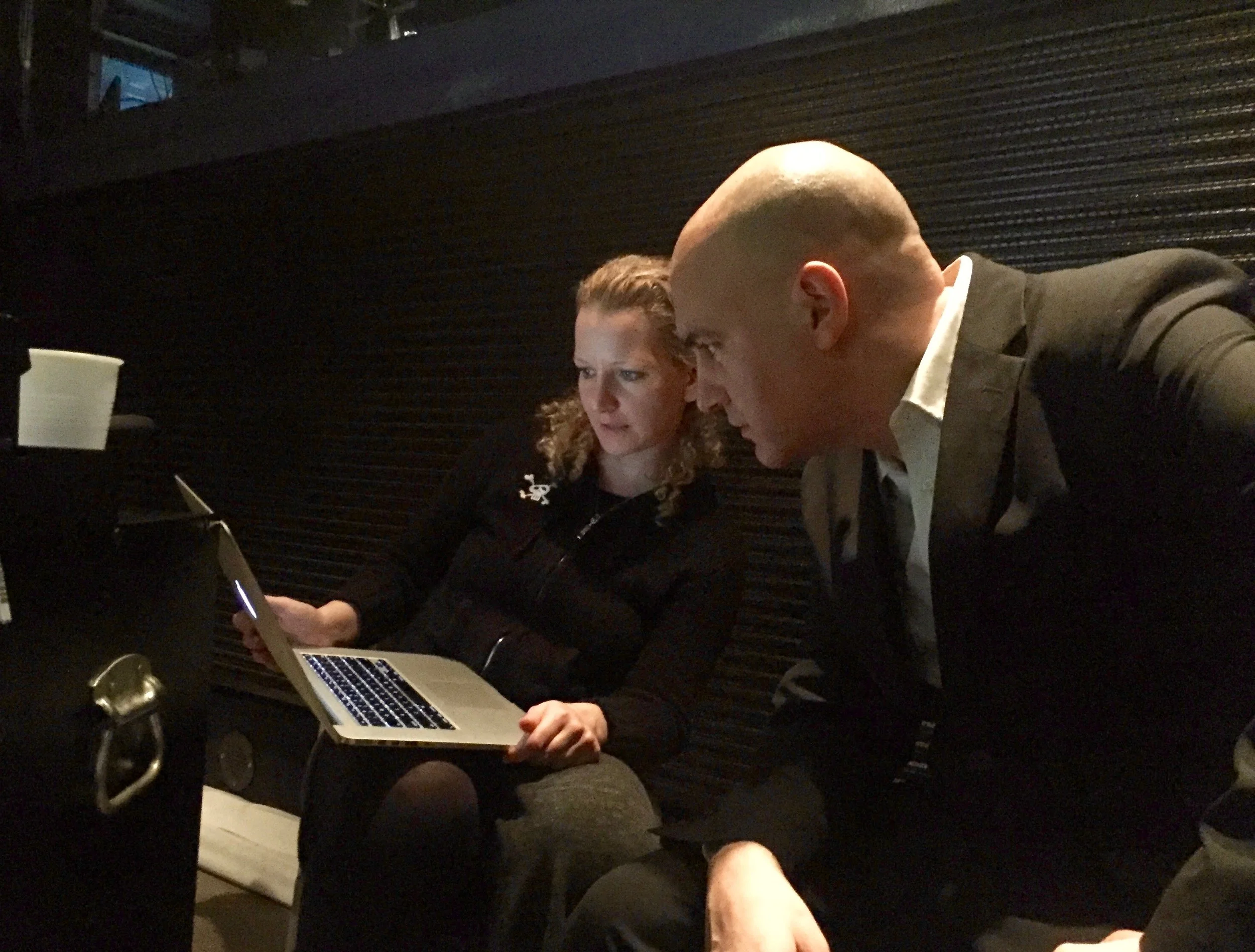 Videographer Cheyenne and Photographer Eryc Whiteley sitting and working on laptop together at the theater.