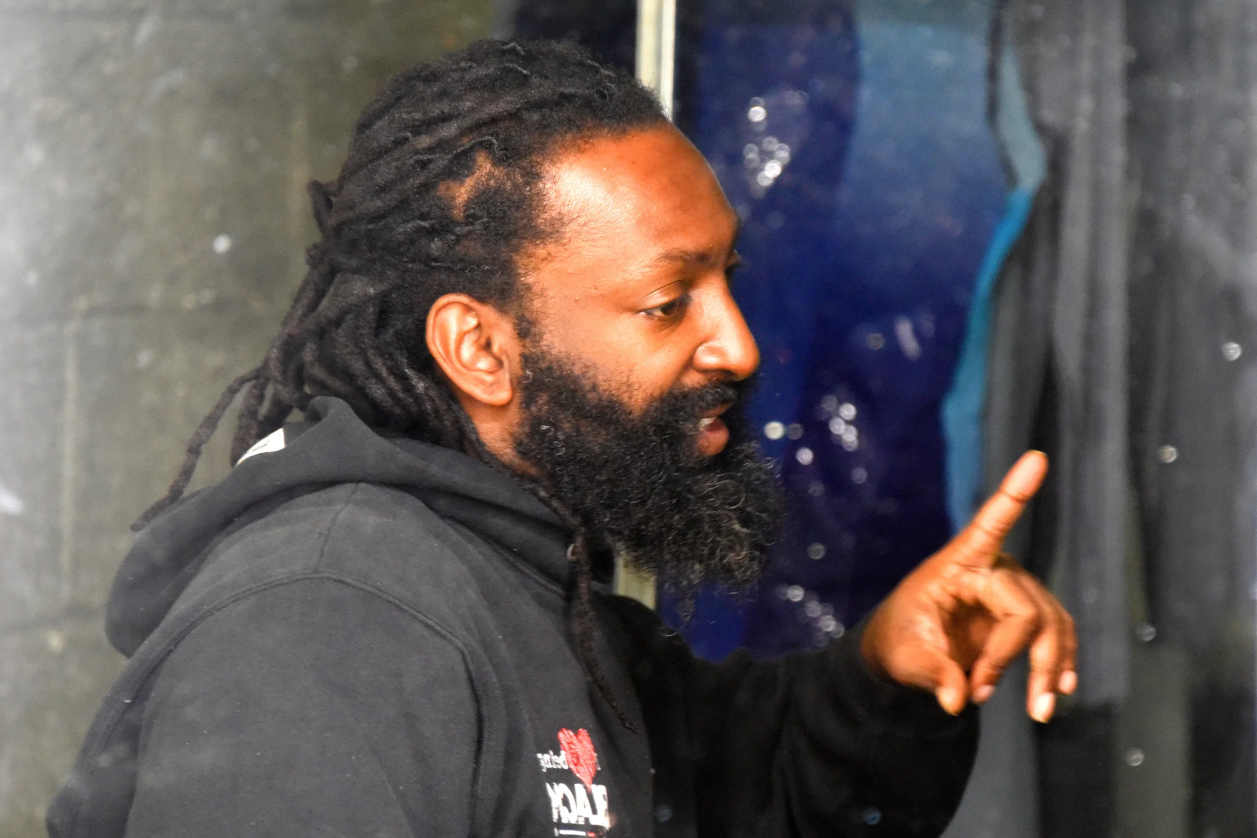 Dancer Antoine Hunter in the dressing room having a conversation in American Sign Language.