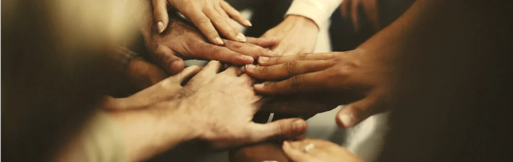 people-stacking-hands-as-team.jpeg