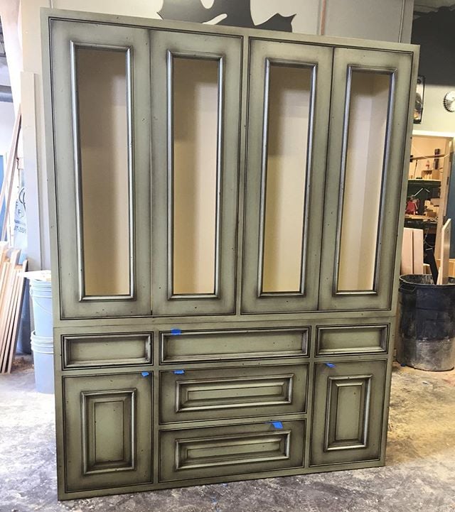 Love this green and cream custom hutch. Beautiful centerpiece to a custom walnut kitchen. #customhutch #timelessmillworks #customcabinets