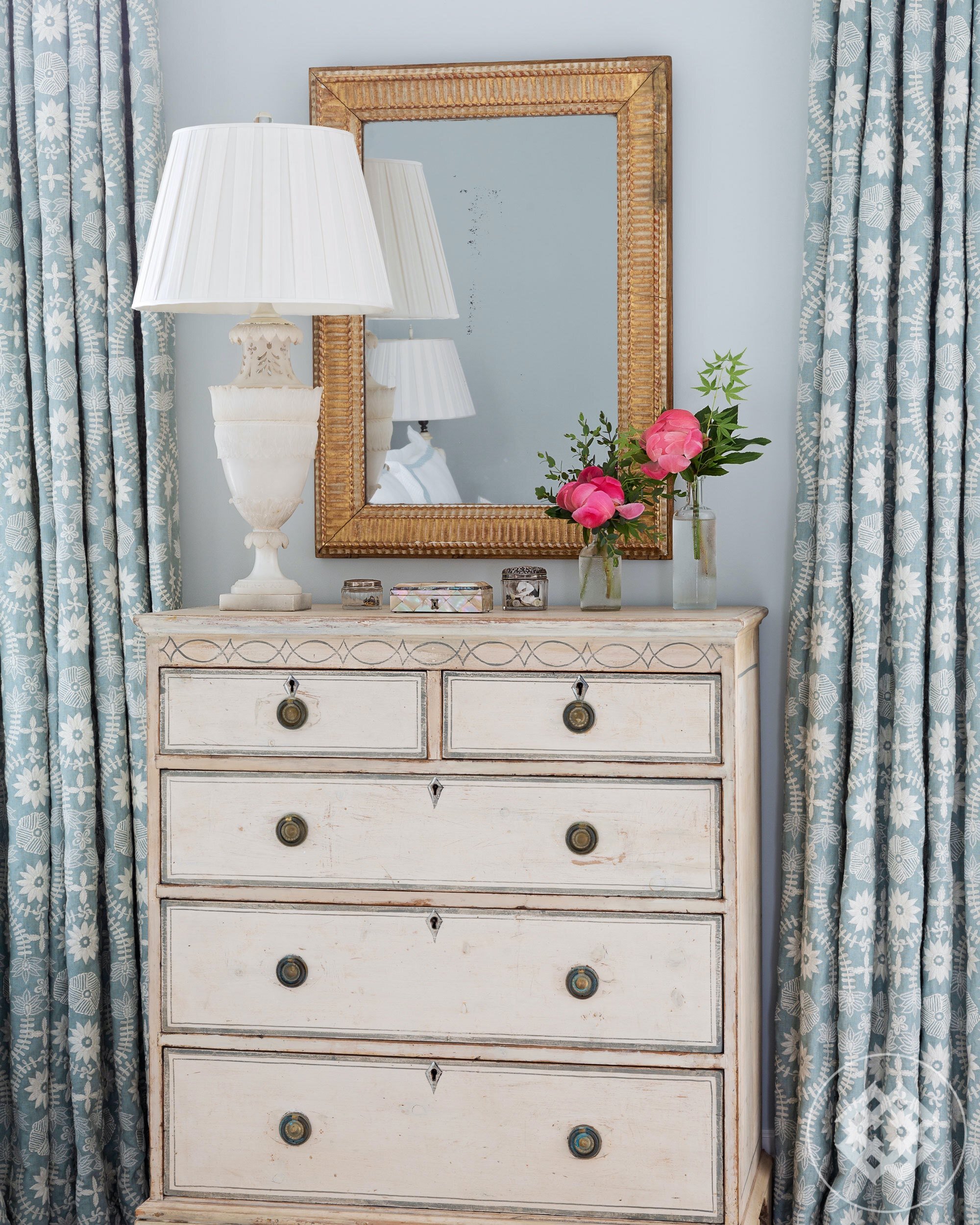 shc-19-embroidered-linen-curtains-flank-an-antique-painted-chest-of-drawers.jpg