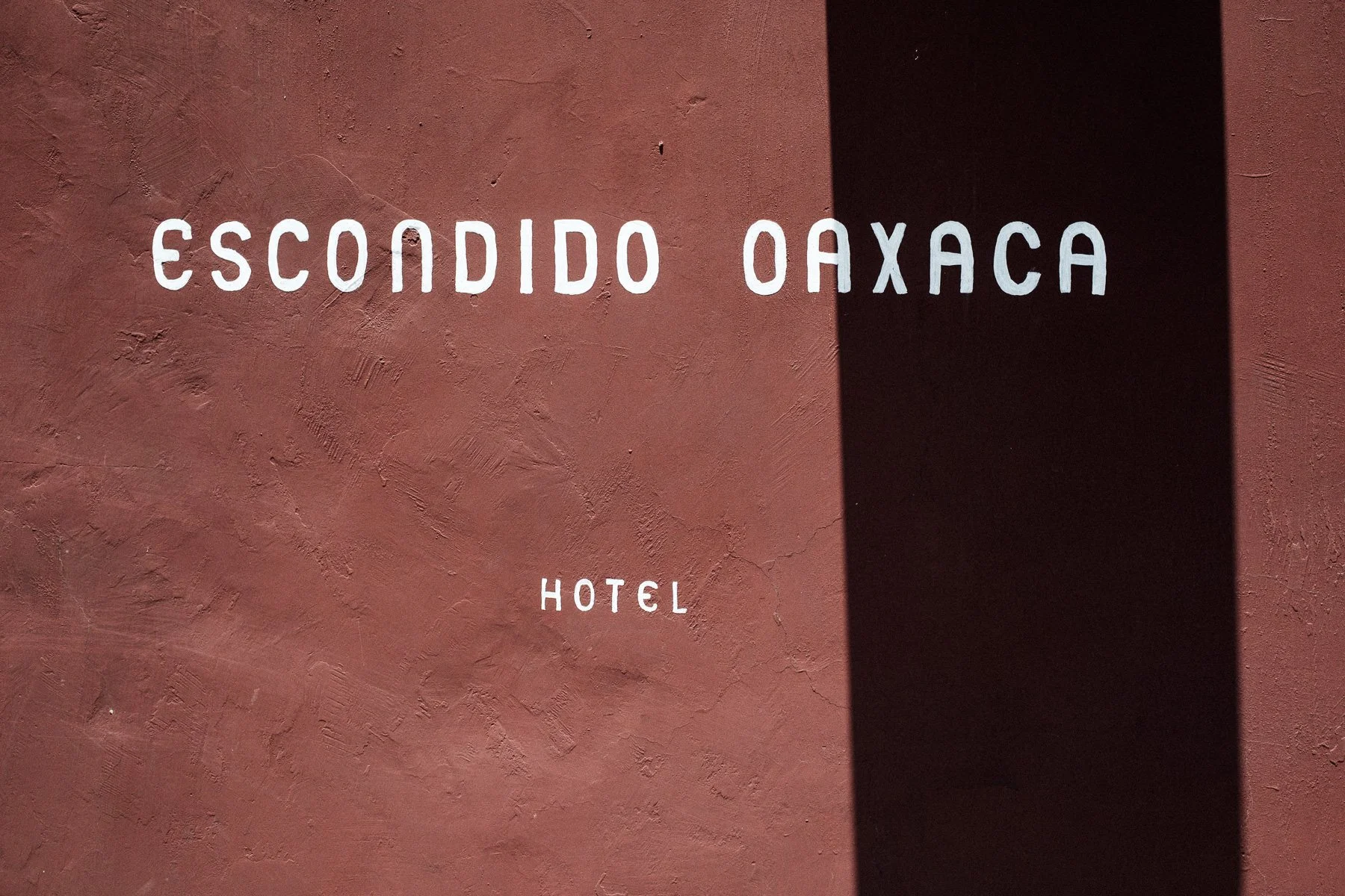 The distinctive wine-colored architecture of Hotel Escondido Oaxaca, a boutique wedding venue.