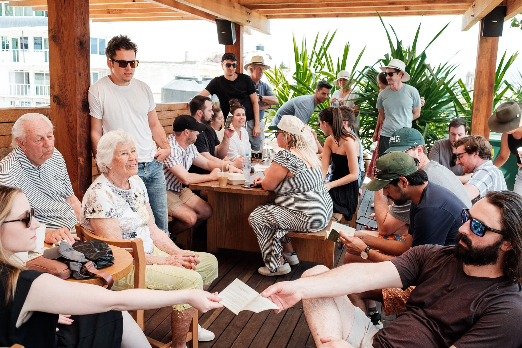 Wedding guests enjoying a Mezcaloteca tasting on the terrace of Hotel Escondido Oaxaca.