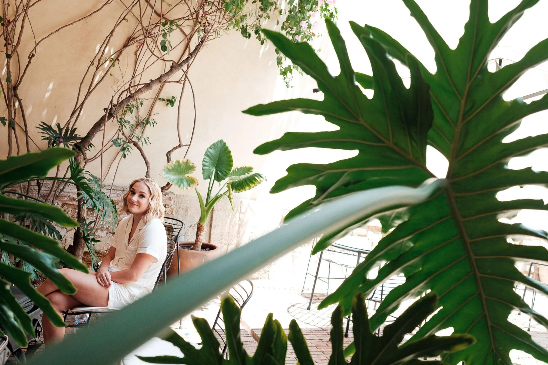 Bride getting her makeup done at Hotel Escondido Oaxaca, framed by lush courtyard greenery.
