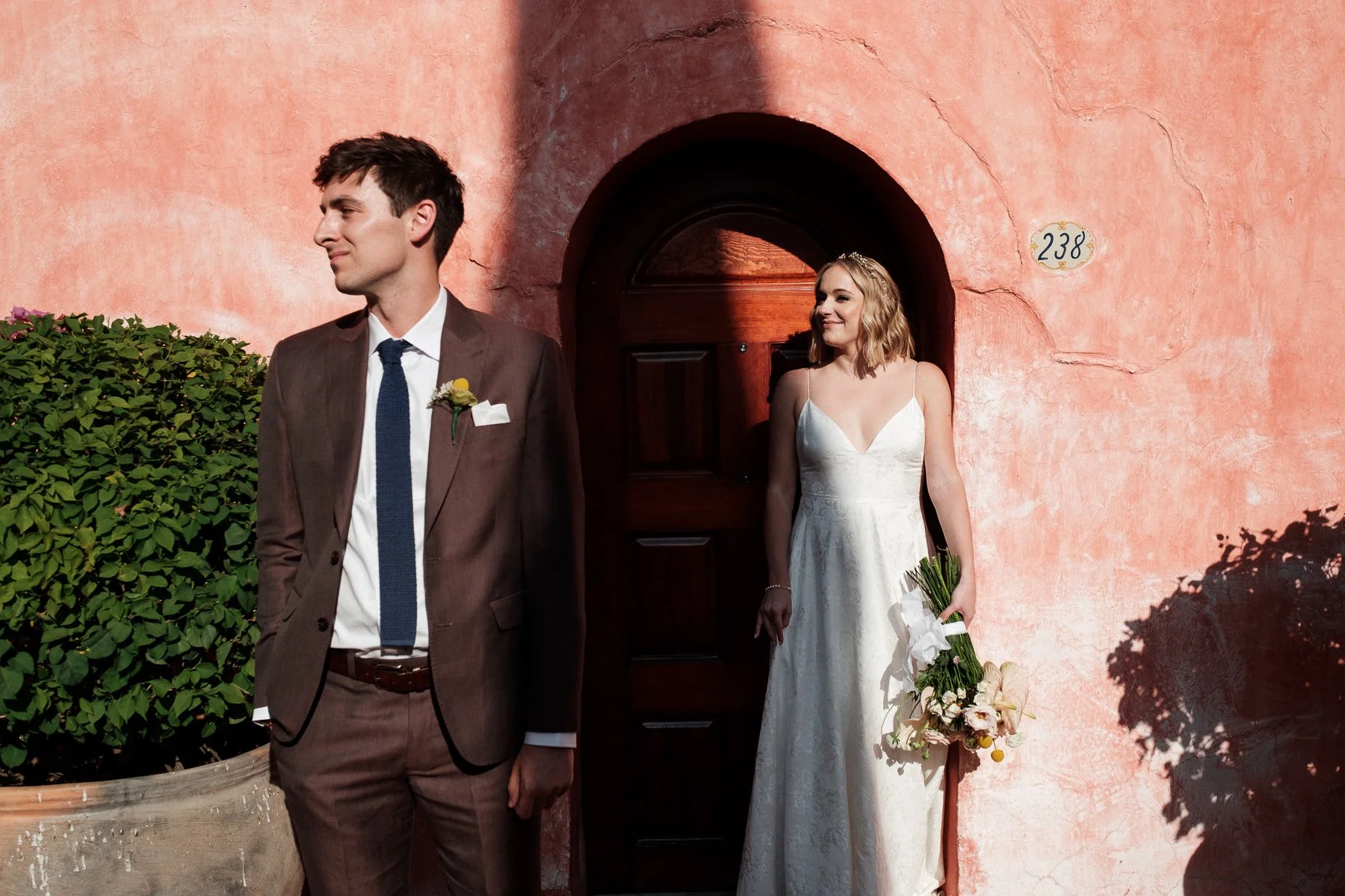 Wedding portraits against the famous pink walls of Quinta Real, captured by Lucca Lazzarini.