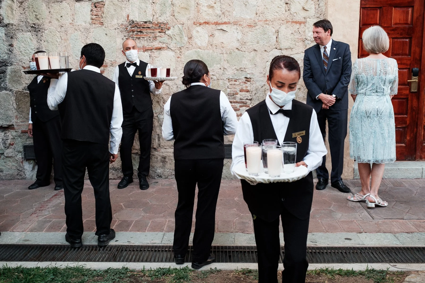 Layered documentary photography of waiters and family during the wedding preparations at Quinta Real.