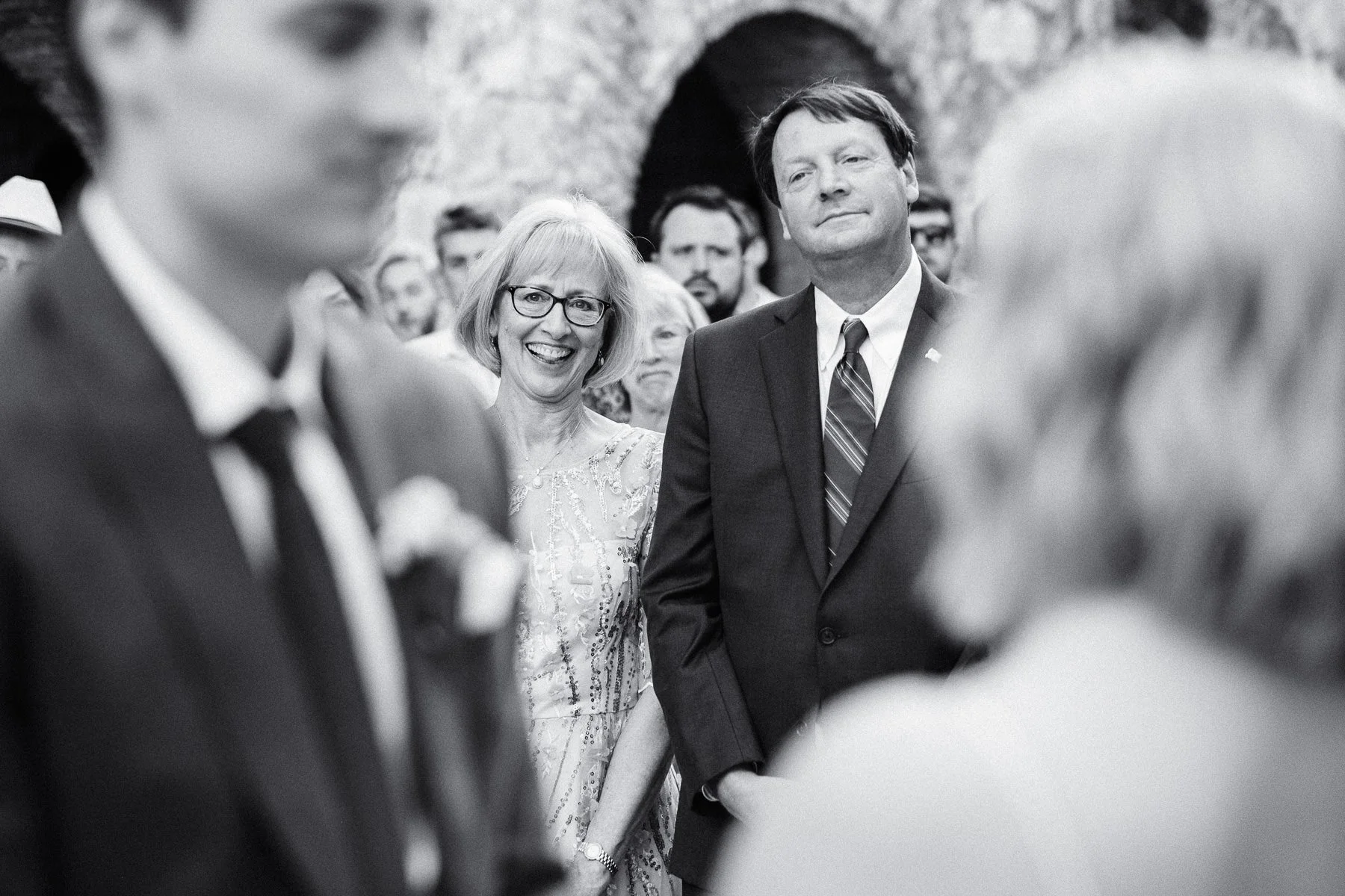 Groom's parents watching the ceremony with emotion, captured through a documentary lens by Lucca Lazzarini.