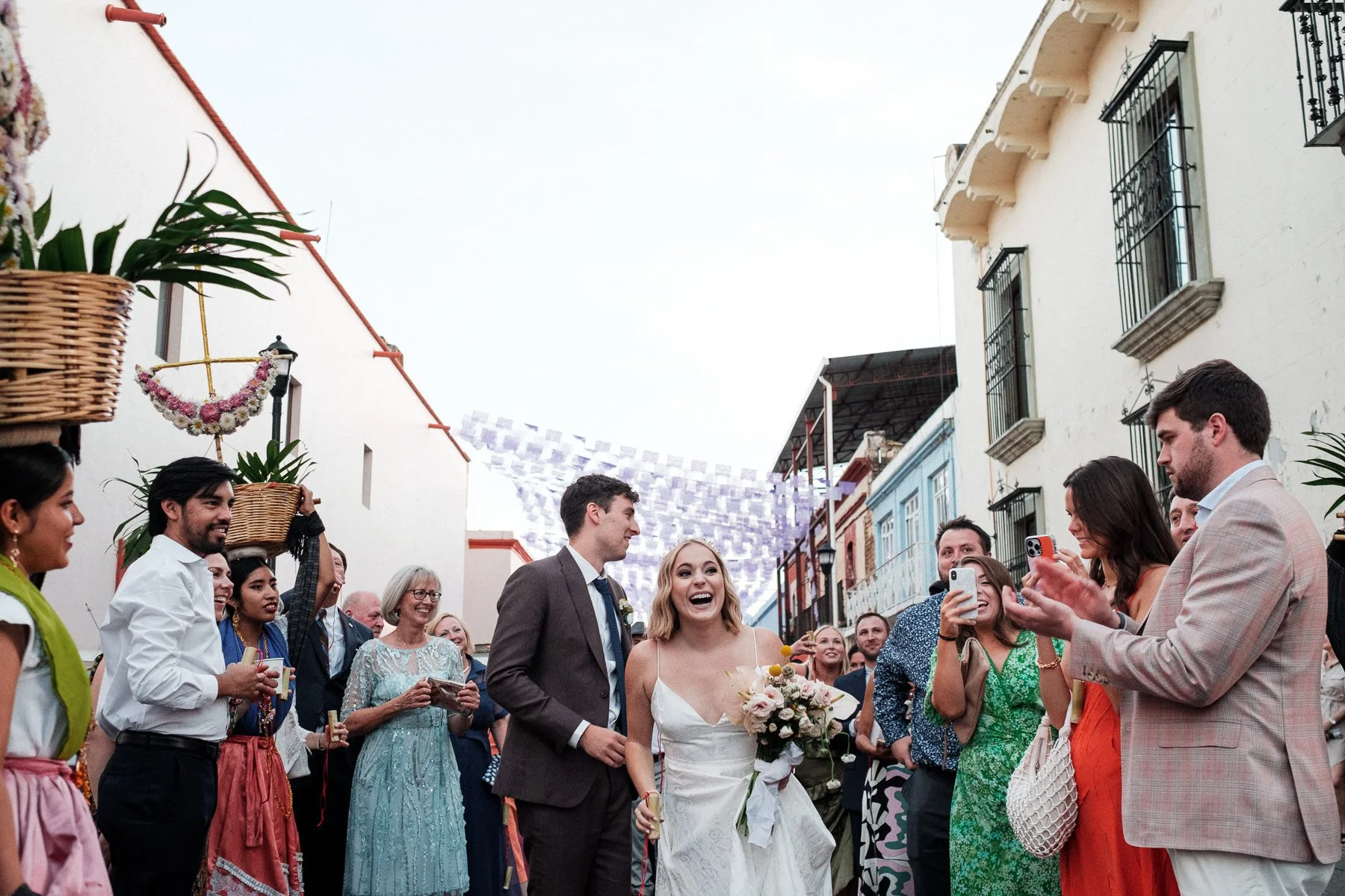 The couple at the heart of their colorful wedding Calenda through the streets of Oaxaca.