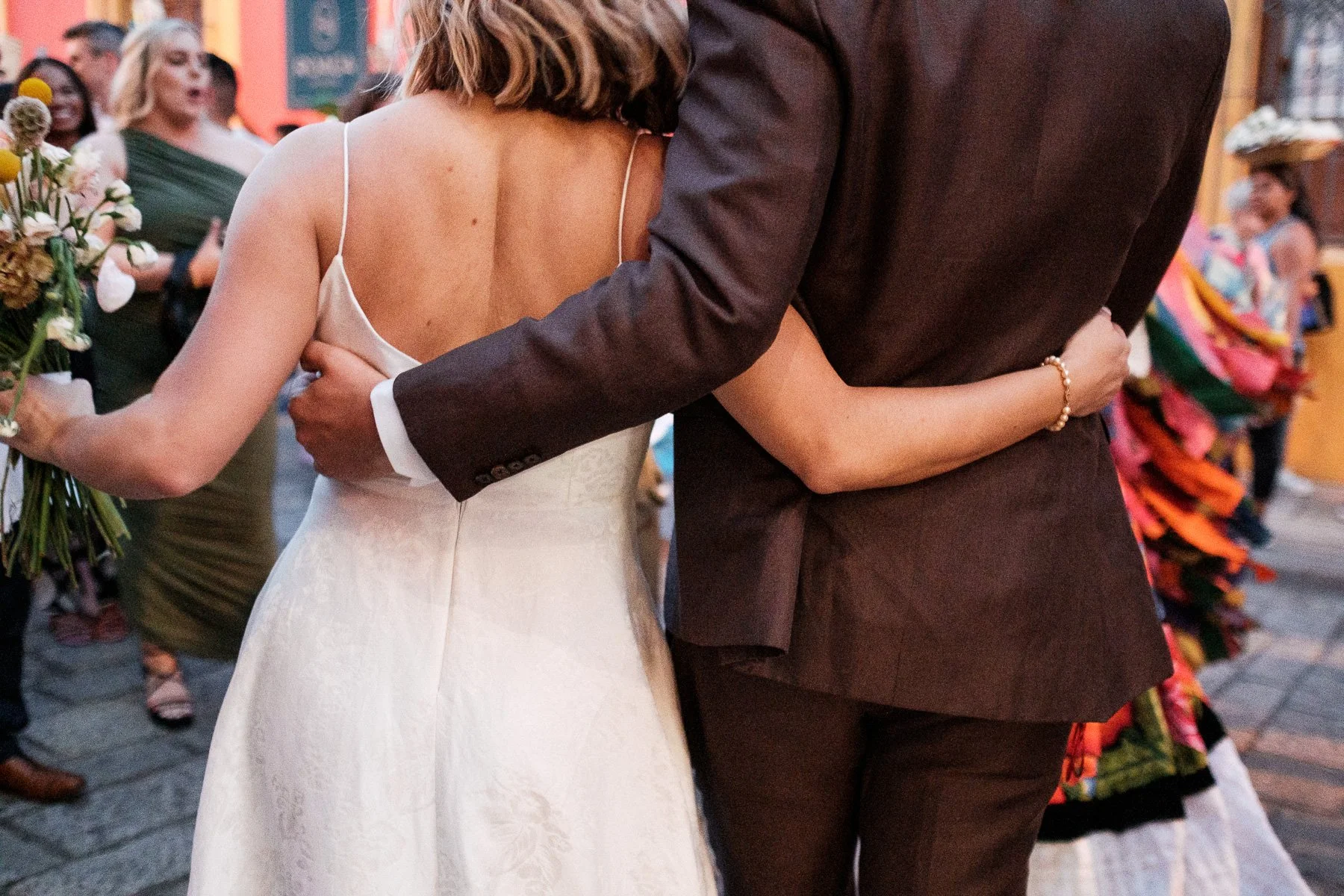 An intimate documentary moment amidst the celebration of an Oaxacan wedding parade.