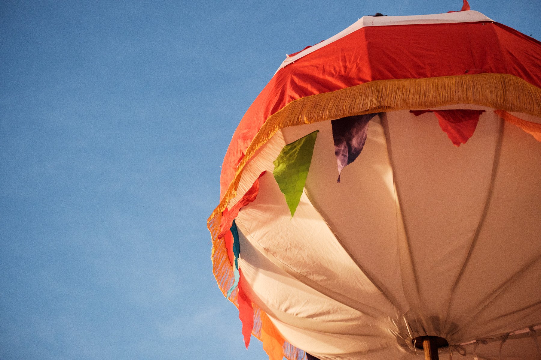 A colorful traditional Calenda ball against the Oaxacan sky, a documentary wedding detail.