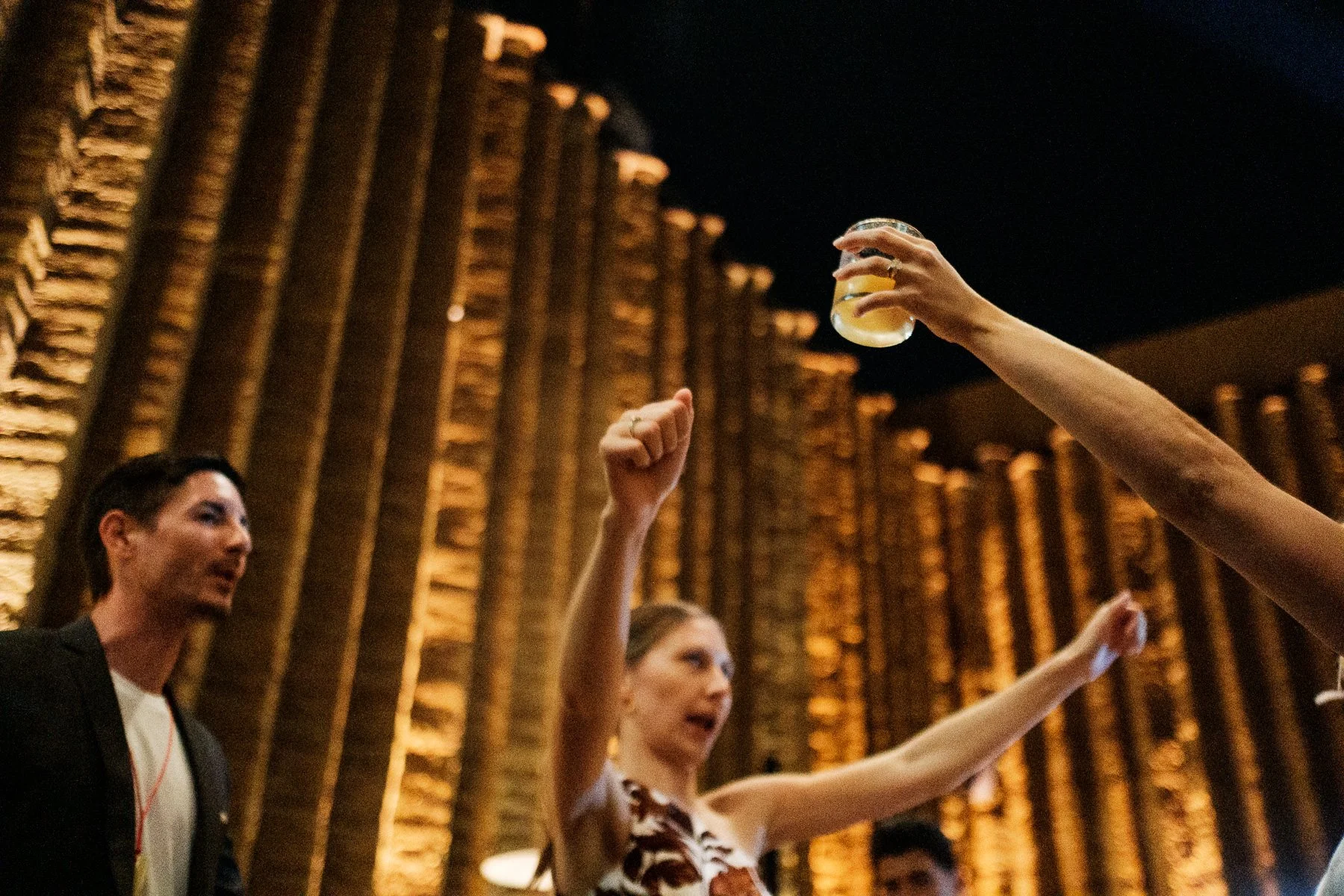 Documentary wedding photography capturing the layered atmosphere of a reception at Los Danzantes.