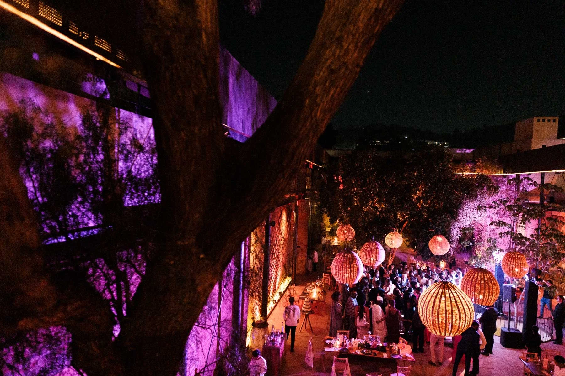 High-angle terrace view showing the vibrant dance floor, colorful decor, and industrial layout of a wedding at La Fabrica Patio.