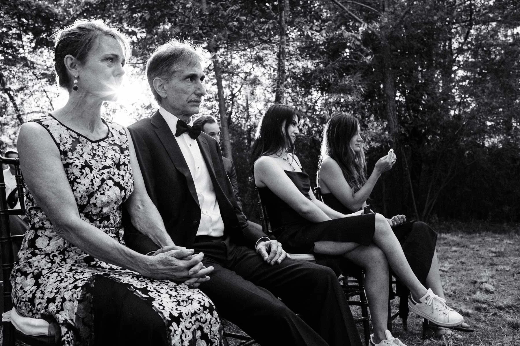 Candid shot of the groom's parents showing emotion during the outdoor forest wedding ceremony at Casa Dos Lagos Oaxaca.