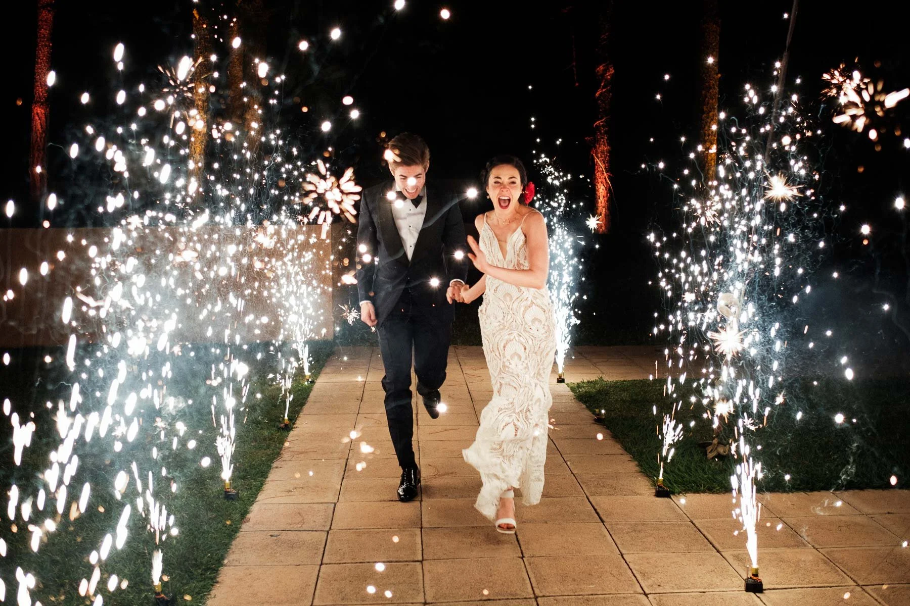 Spectacular grand entrance of the couple into their wedding reception at Casa Dos Lagos, framed by bright fireworks and celebration.