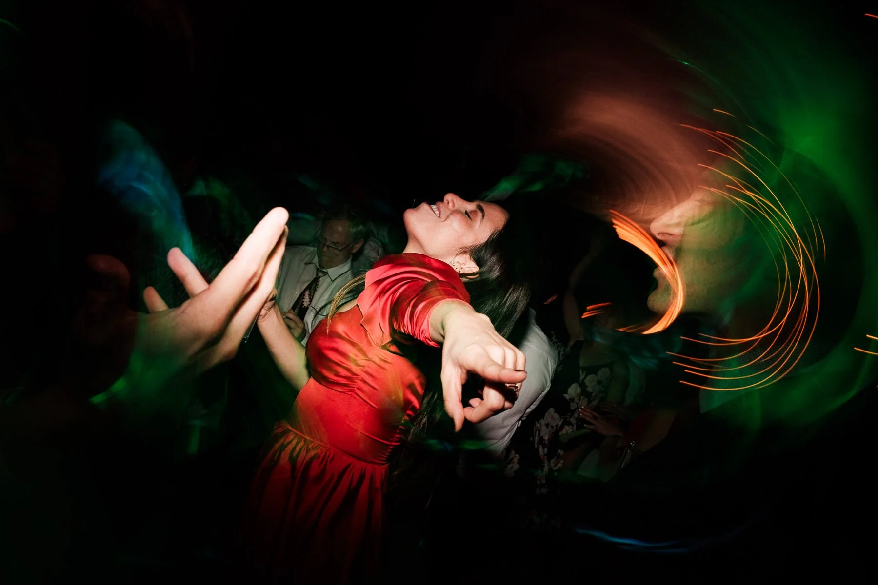 A wedding guest captured in a unique and joyful dancing moment during the party at Casa Dos Lagos.