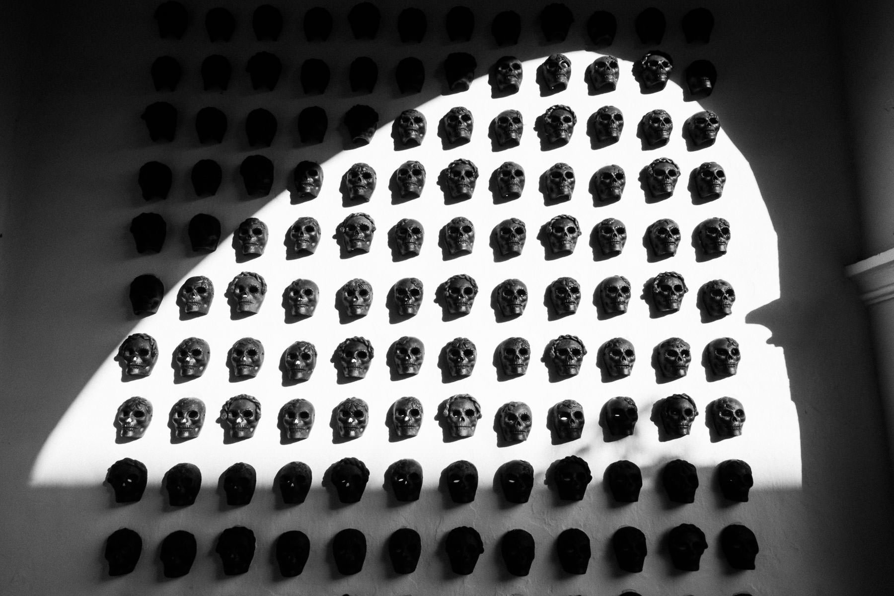 Artistic skeletal 'calaveras' decor on the walls of Casa Convite, showcasing the unique Oaxacan soul and character of the venue.