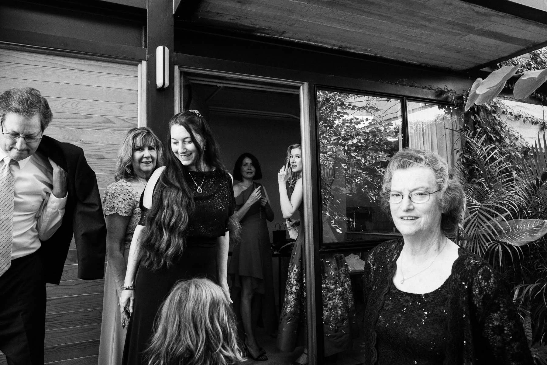 A documentary photo of the family gathering just before leaving for the ceremony.