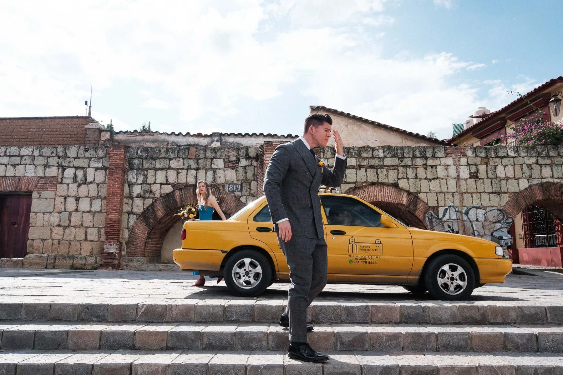 A spontaneous moment of the couple stepping out of a taxi just before their photo walk in Oaxaca.