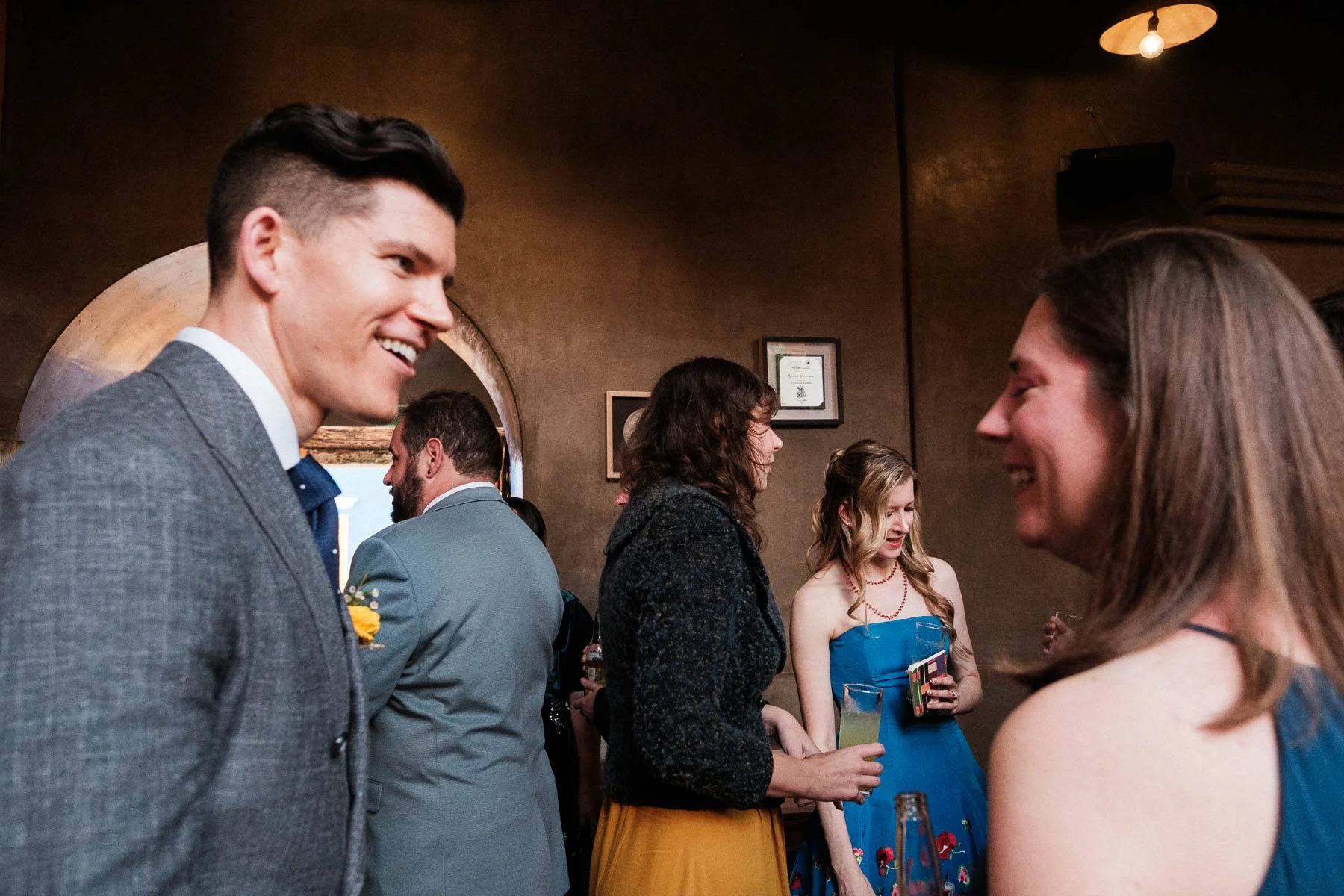 A candid moment of the couple chatting with friends during the outdoor cocktail hour in Oaxaca.