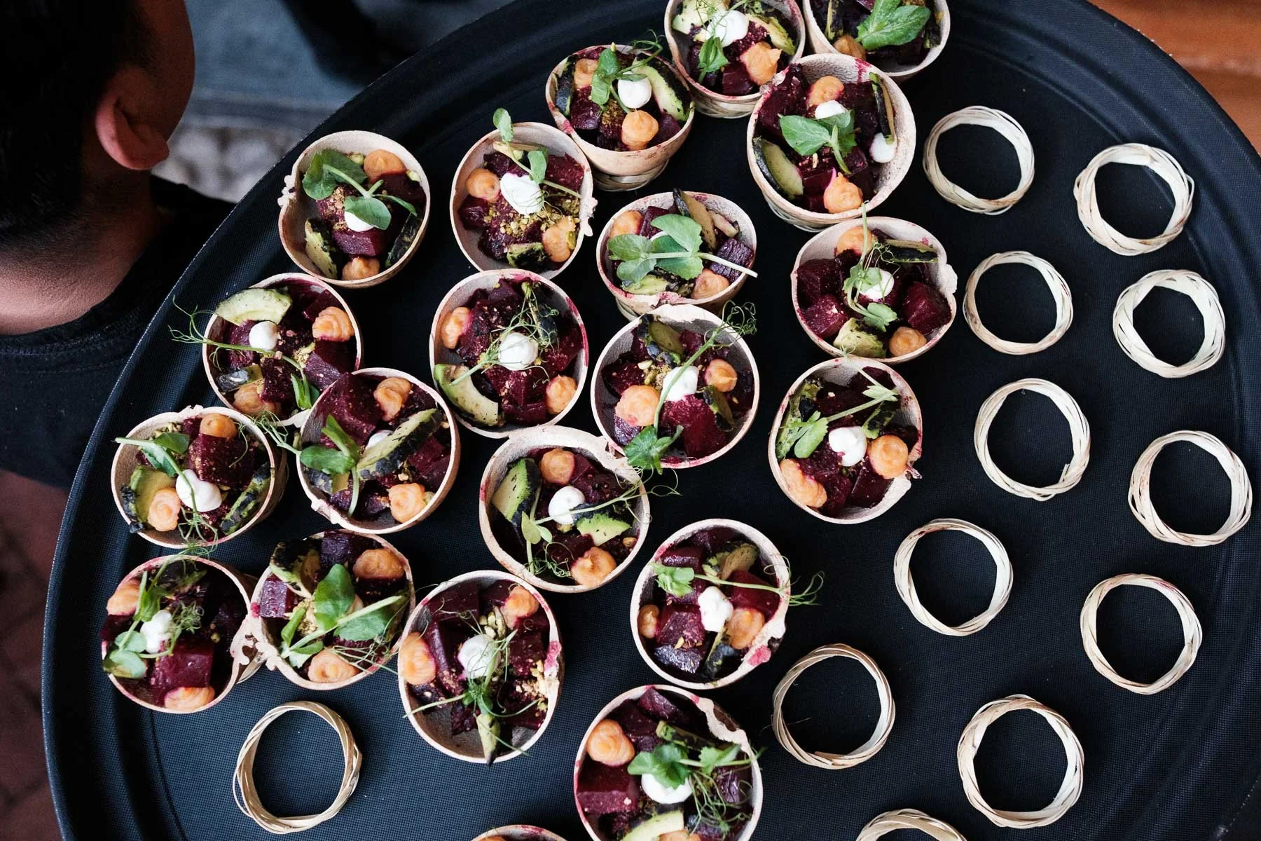 A documentary shot of a waiter serving traditional appetizers during a wedding celebration in Oaxaca.