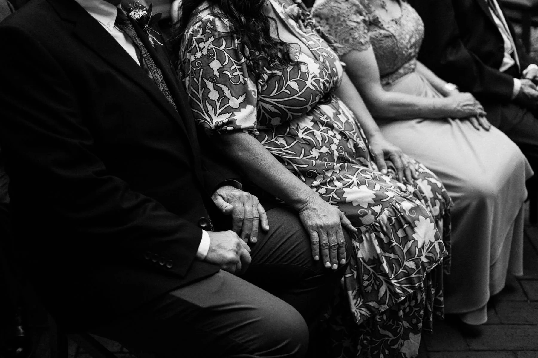 A poignant close-up of the parents' hands during an emotional wedding ceremony in Oaxaca.