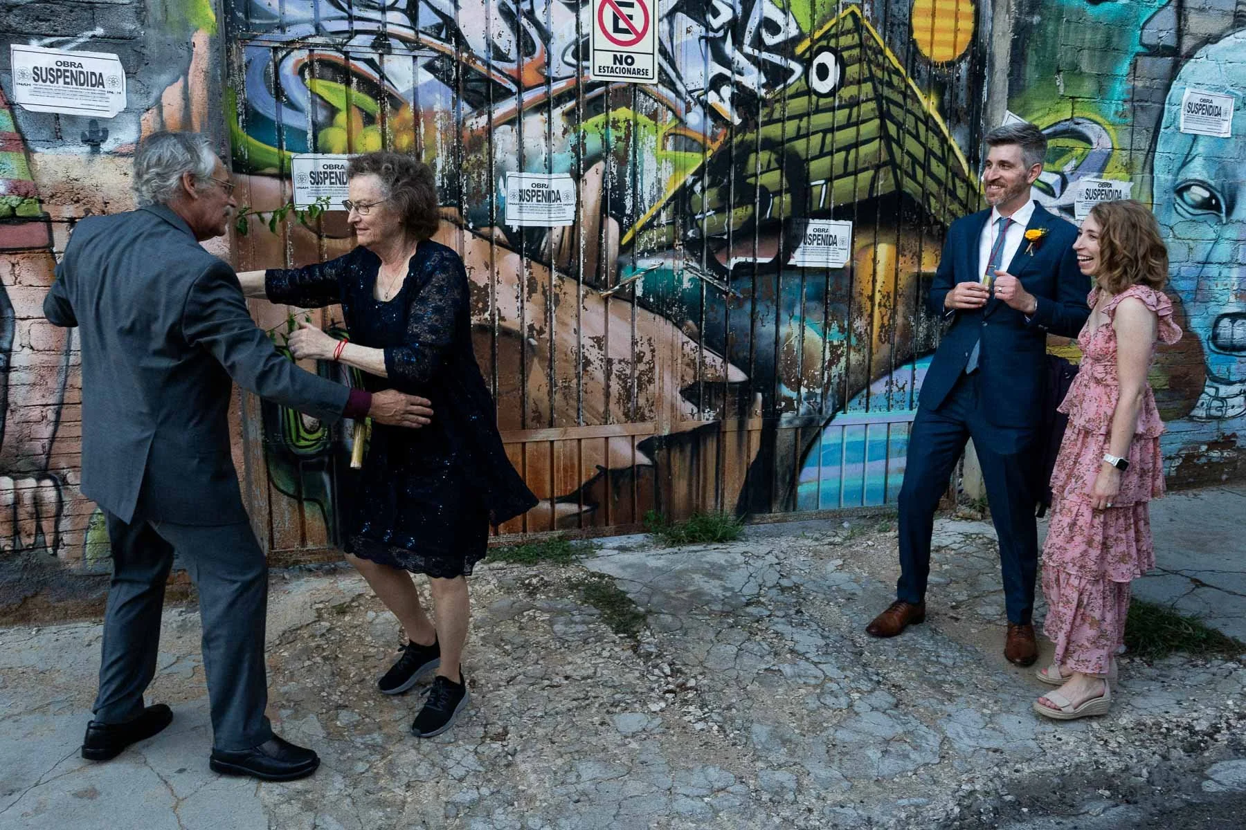 An older couple dancing to the rhythm of the Calenda while younger guests watch with joy.