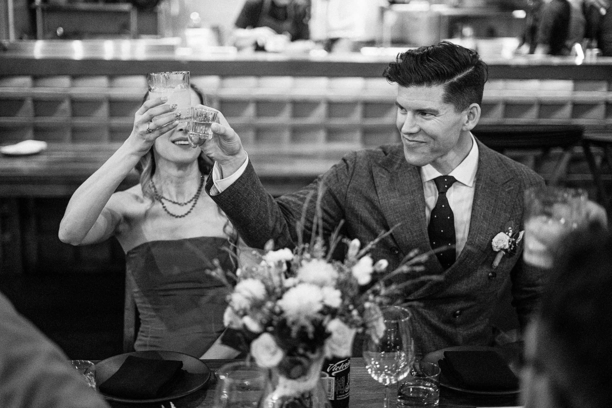 The bride and groom toast during a heartfelt speech at their Asador Bacanora wedding reception.