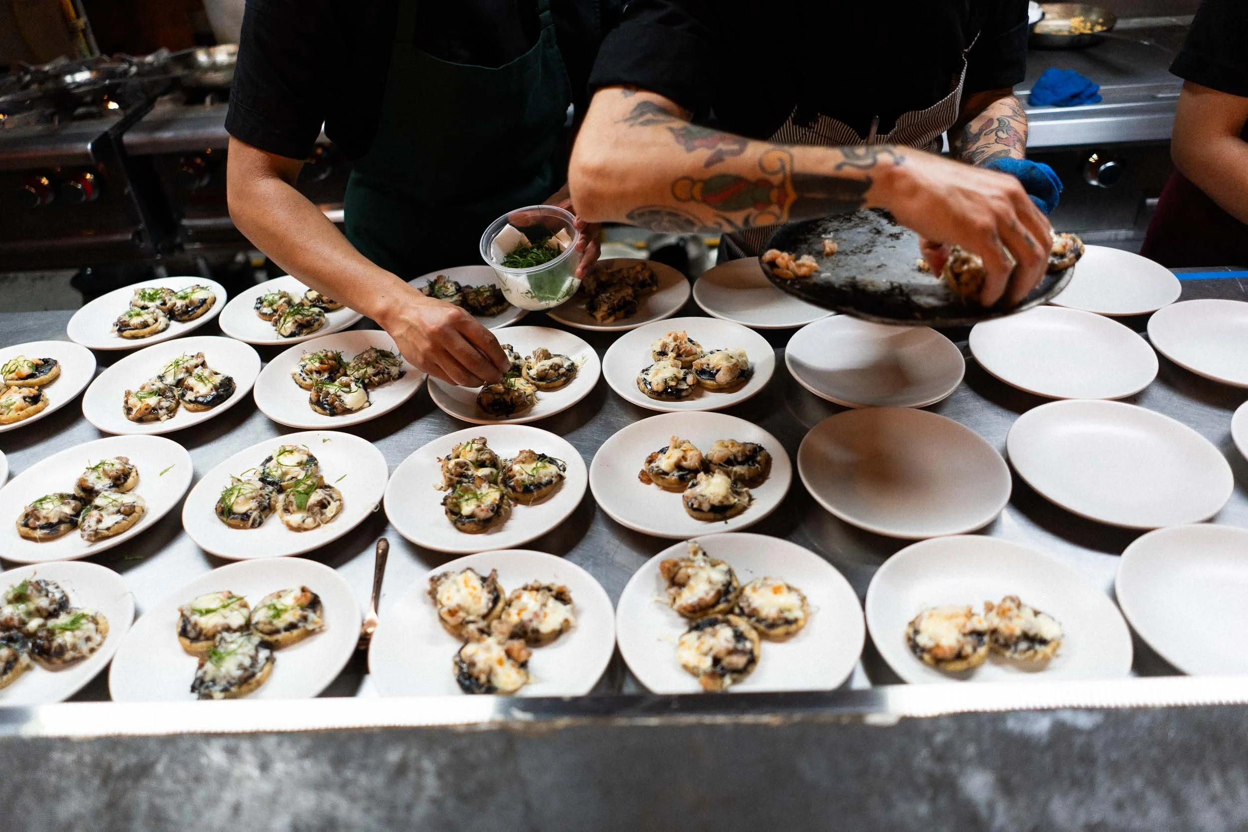 Behind the scenes documentary shot of chefs preparing the wedding feast at Asador Bacanora.