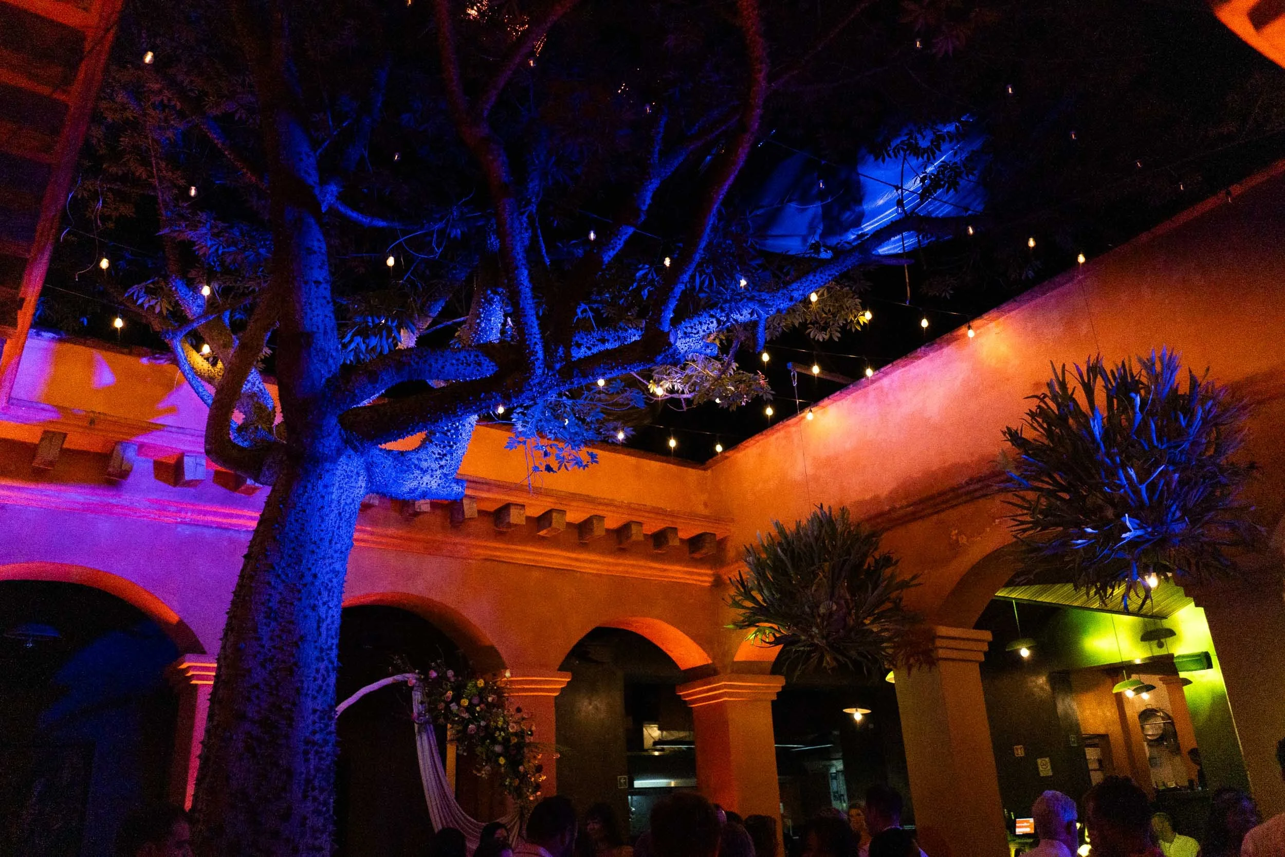 A wide atmospheric shot of Asador Bacanora venue in Oaxaca during the night-time wedding party.
