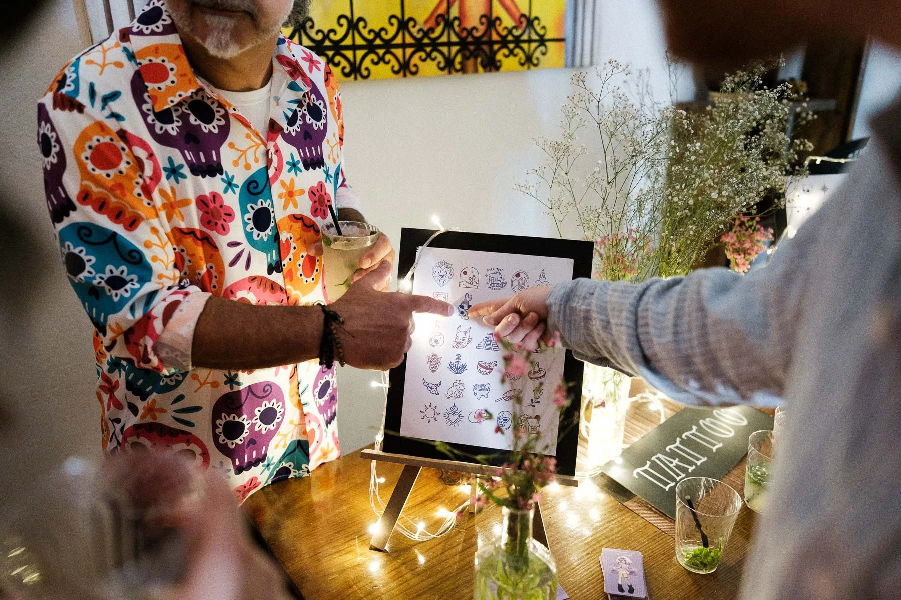 Guests choosing tattoos at a wedding welcome event