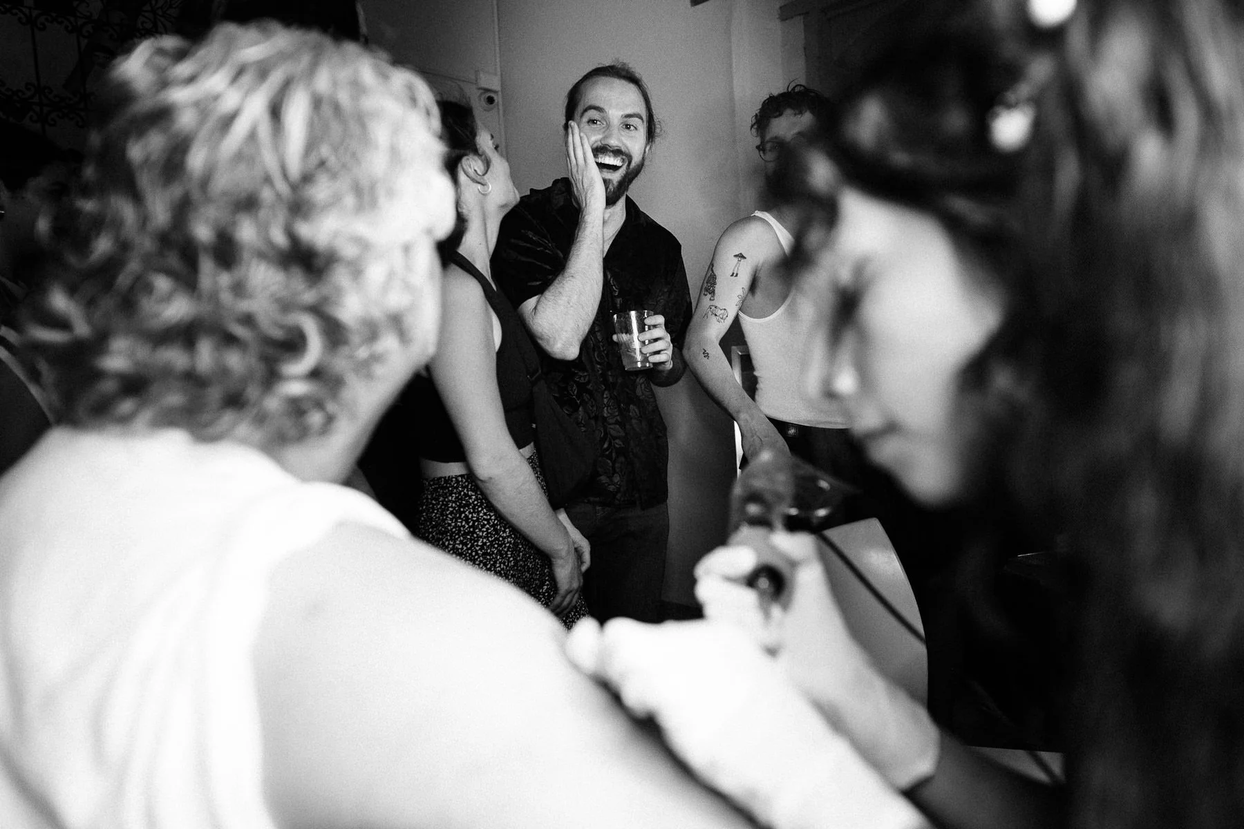 Guest watching father getting tattooed at wedding party