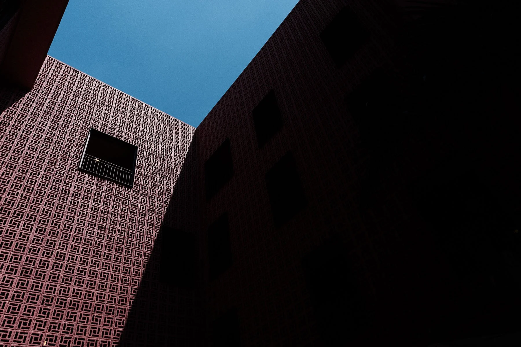 Minimal architectural detail with pink walls and shadows at Hotel City Centro Oaxaca.