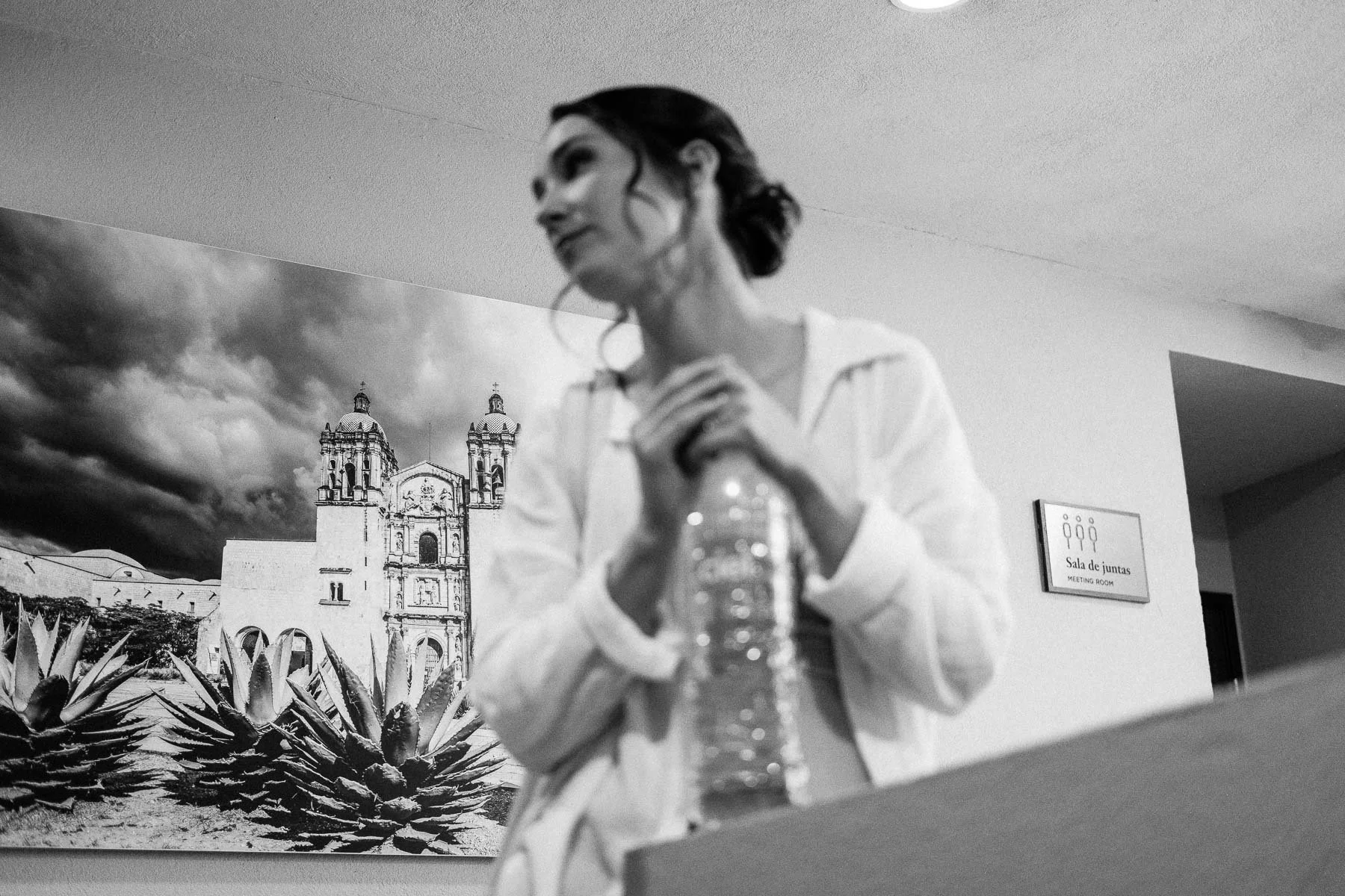 Bride getting ready with Santo Domingo Church painting in the background.