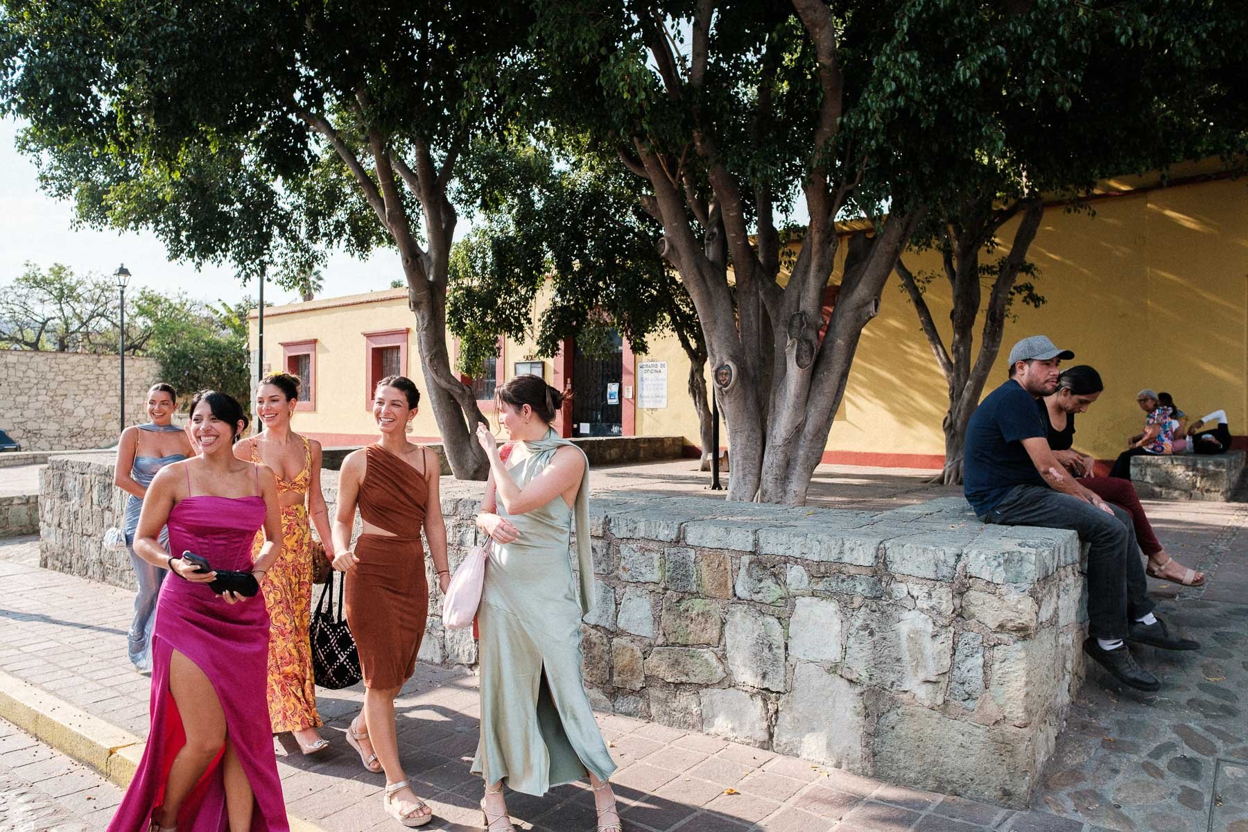 Friends watching the brides walk down the street on their way to the ceremony.
