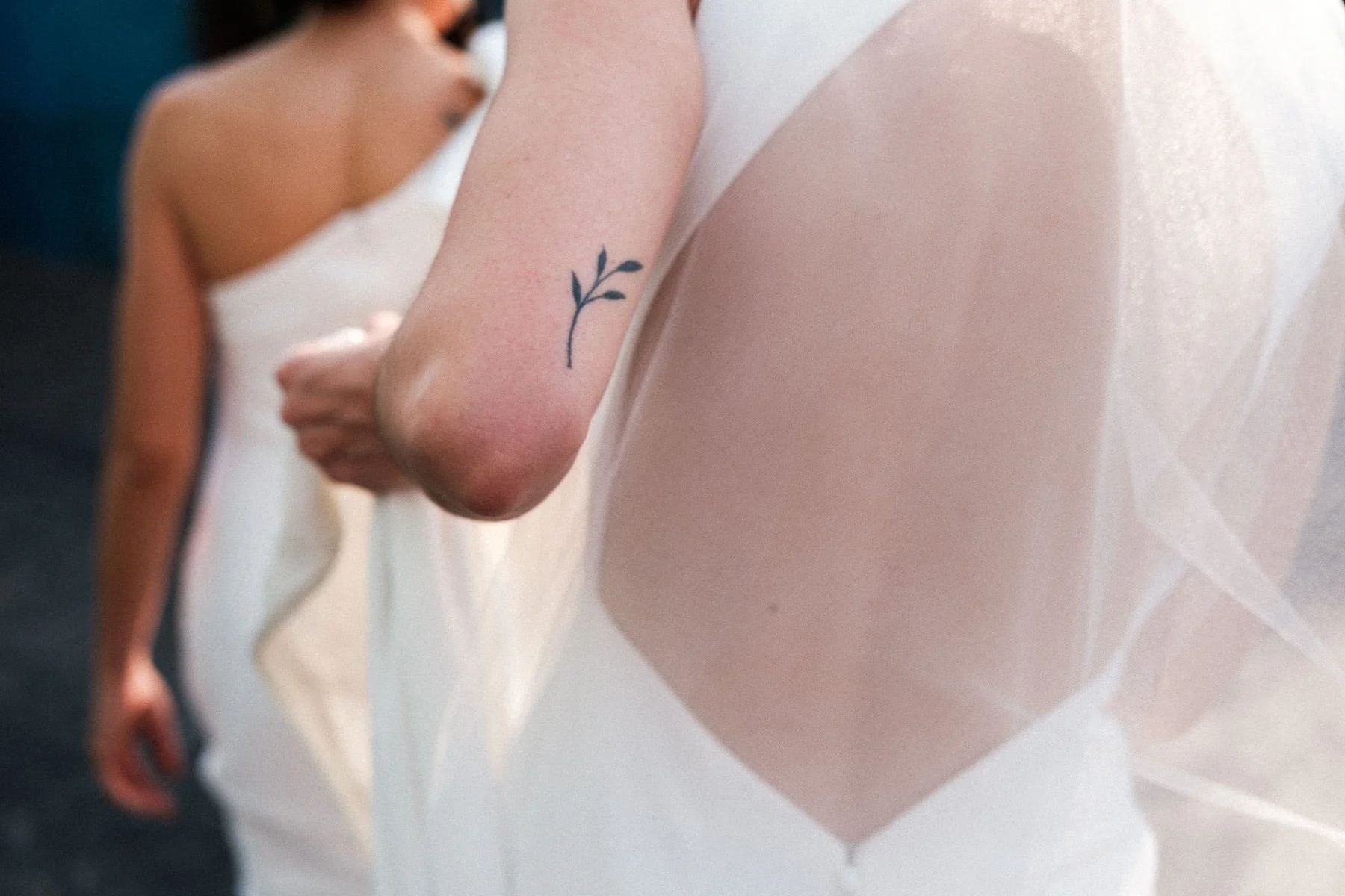 Close-up detail of a bride's tattoo during wedding preparations.