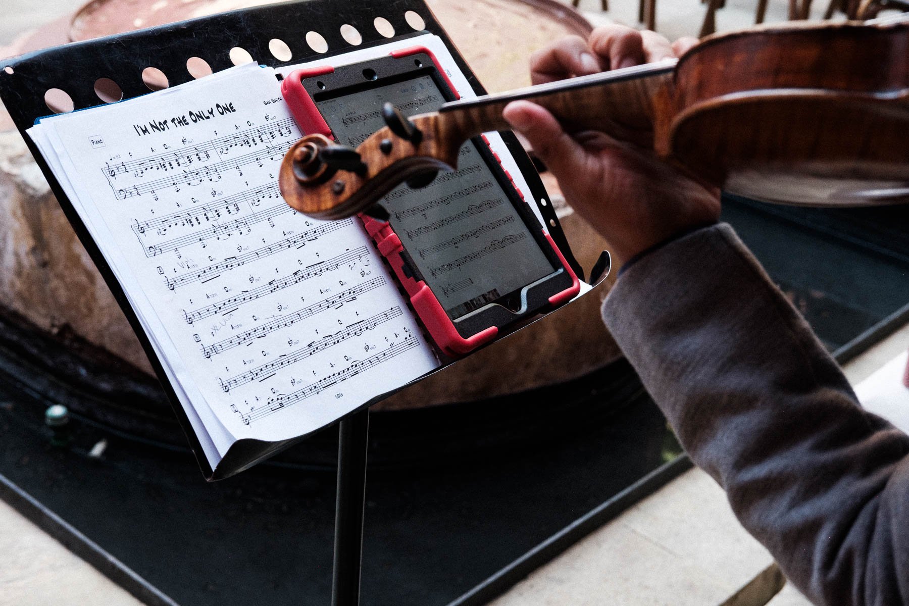 Violin and musical score details before an intimate wedding ceremony.