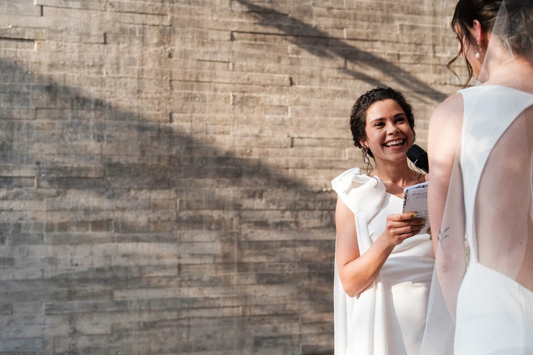Bride smiling while giving her vows, captured by Lucca Lazzarini.
