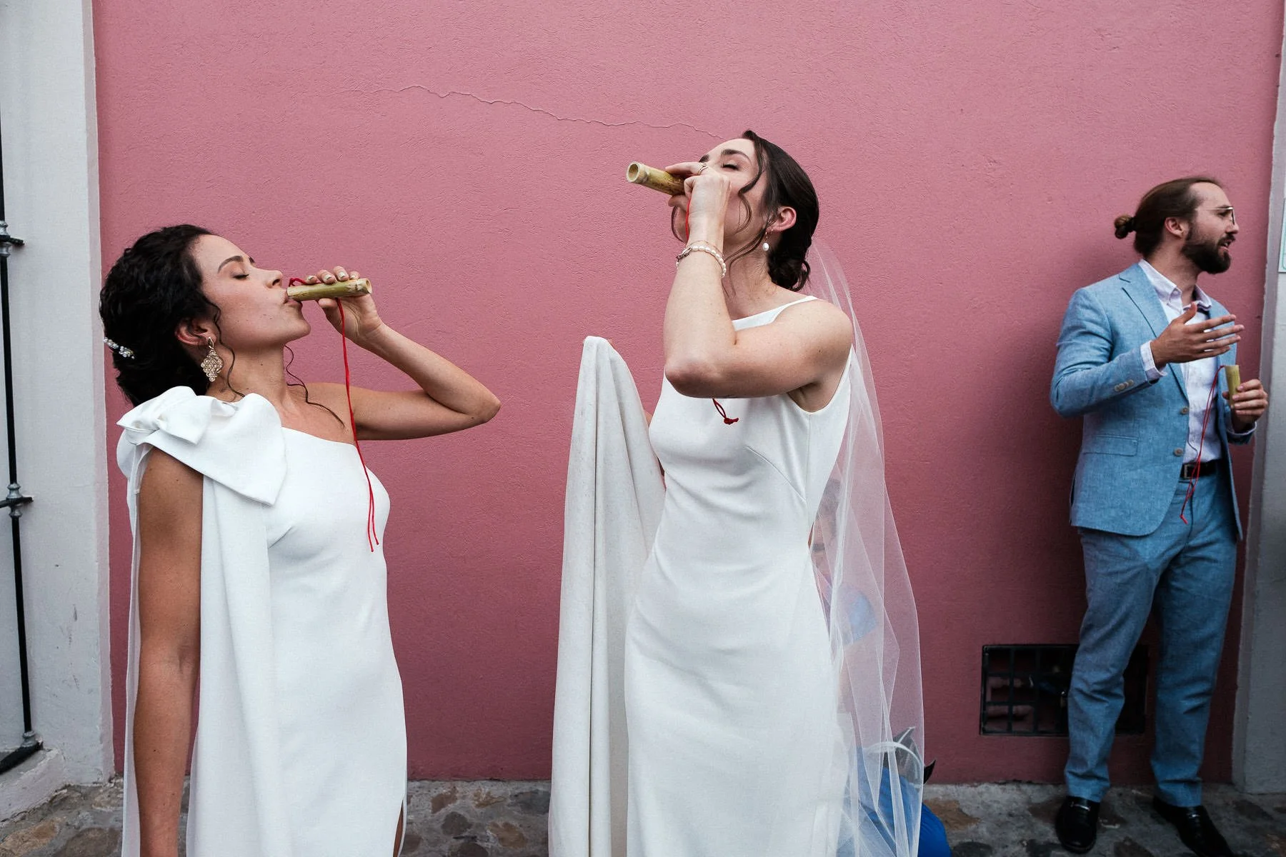 The brides taking mezcal shots to kick off the Calenda in Jalatlaco.