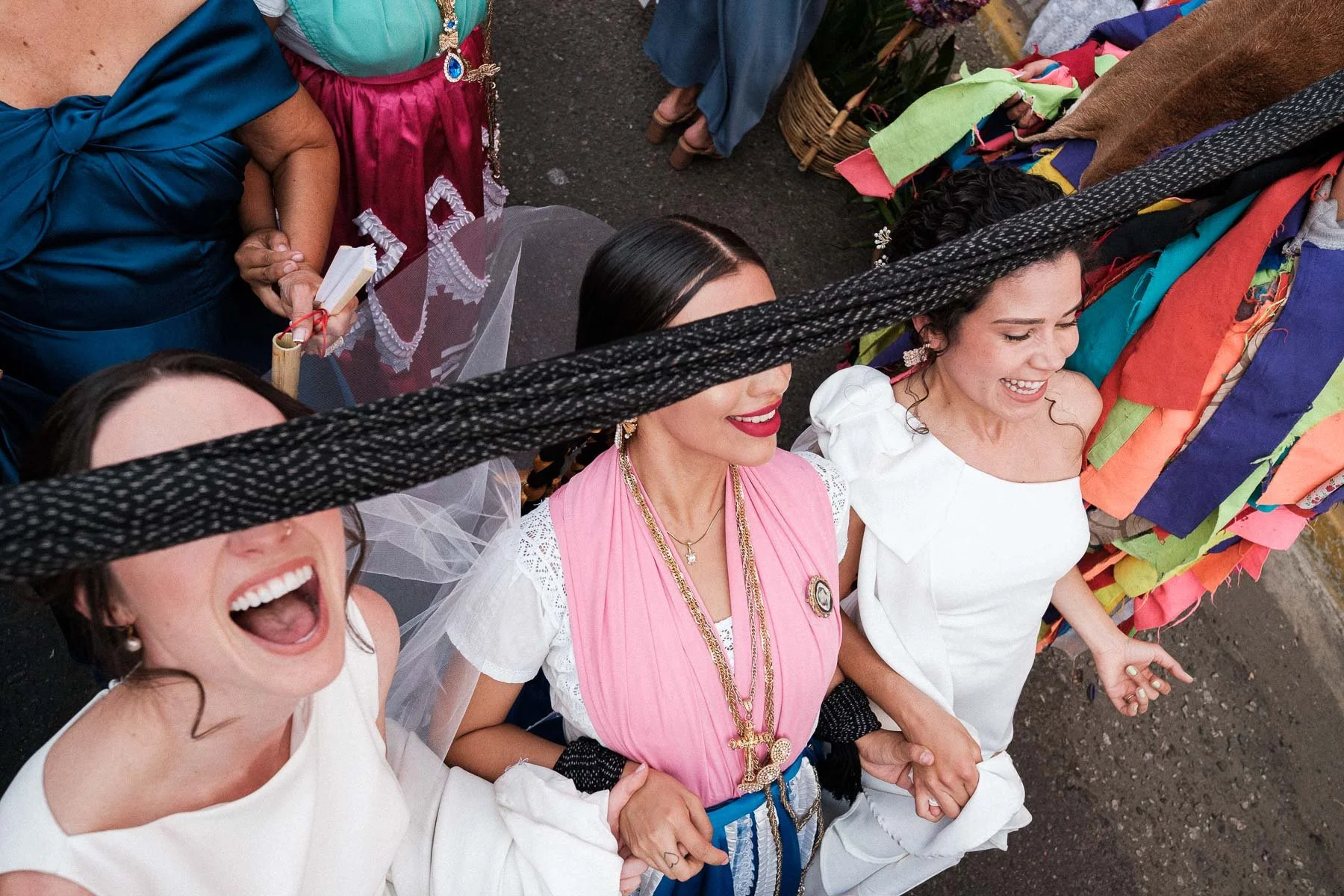 The brides dancing and laughing throughout the traditional Calenda parade.
