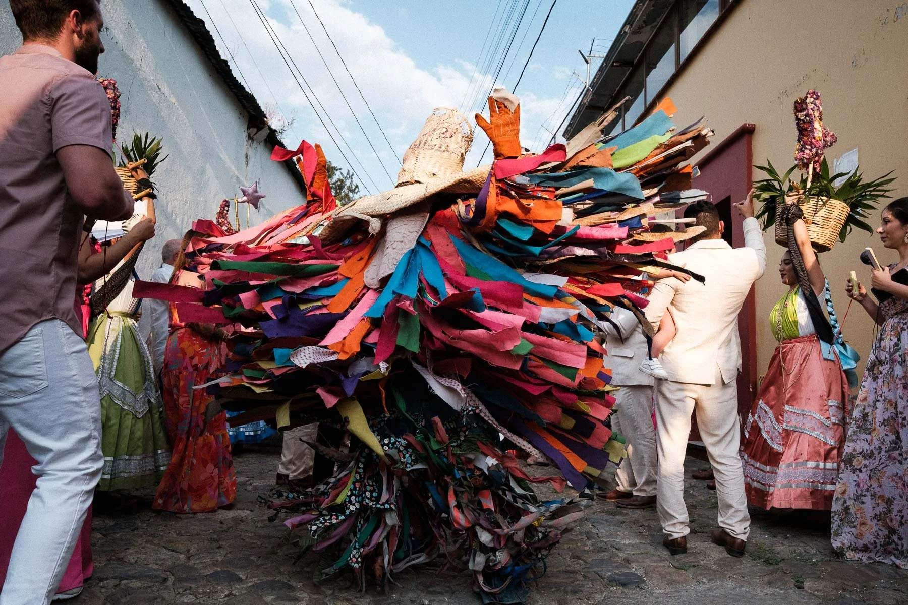 A vibrant, colorful Calenda puppet dancing in the street.