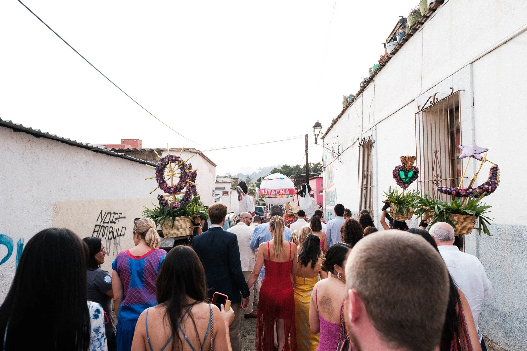 A wide-angle view of the bustling Calenda procession in Oaxaca.