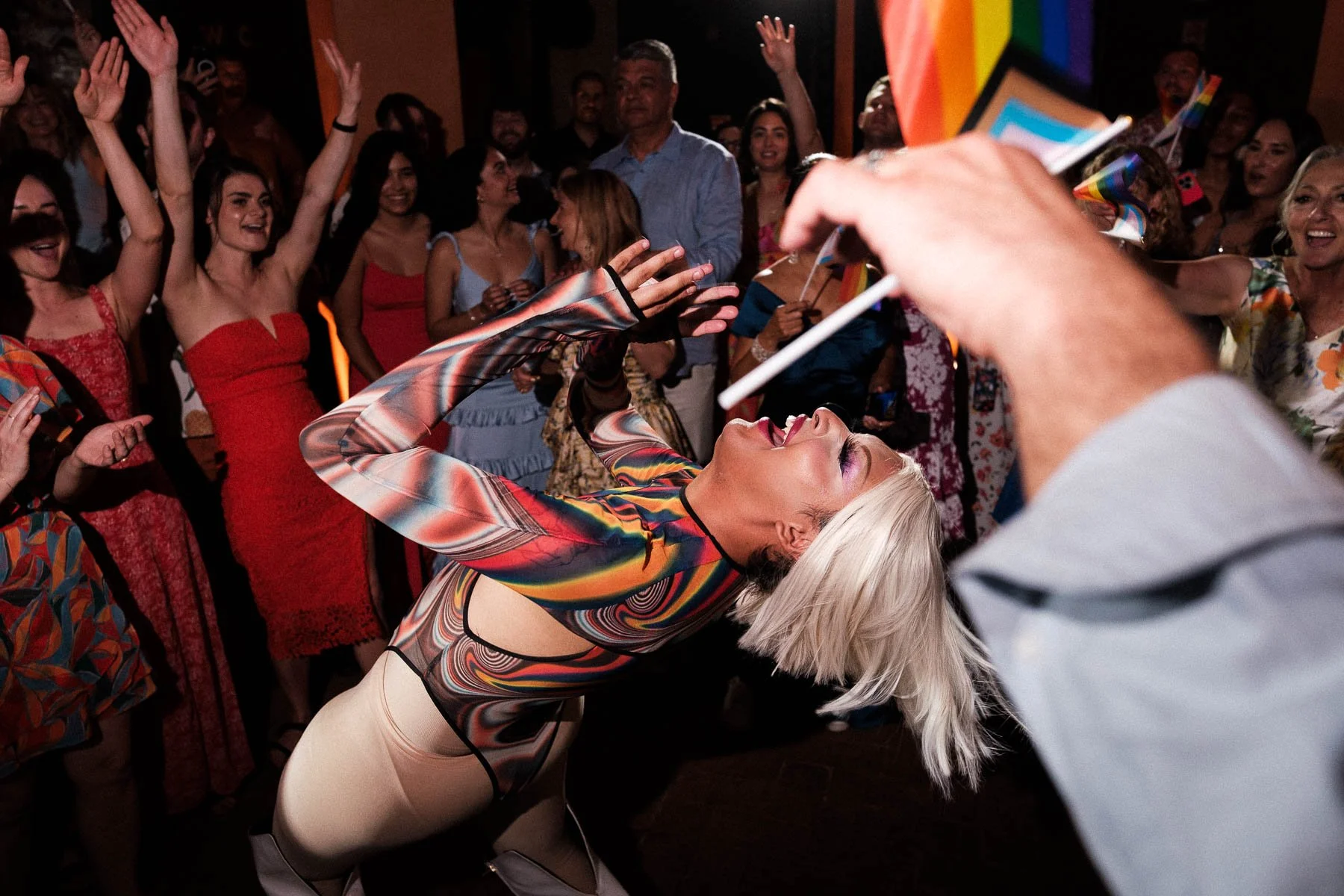A drag queen performing in the center of the dance floor.