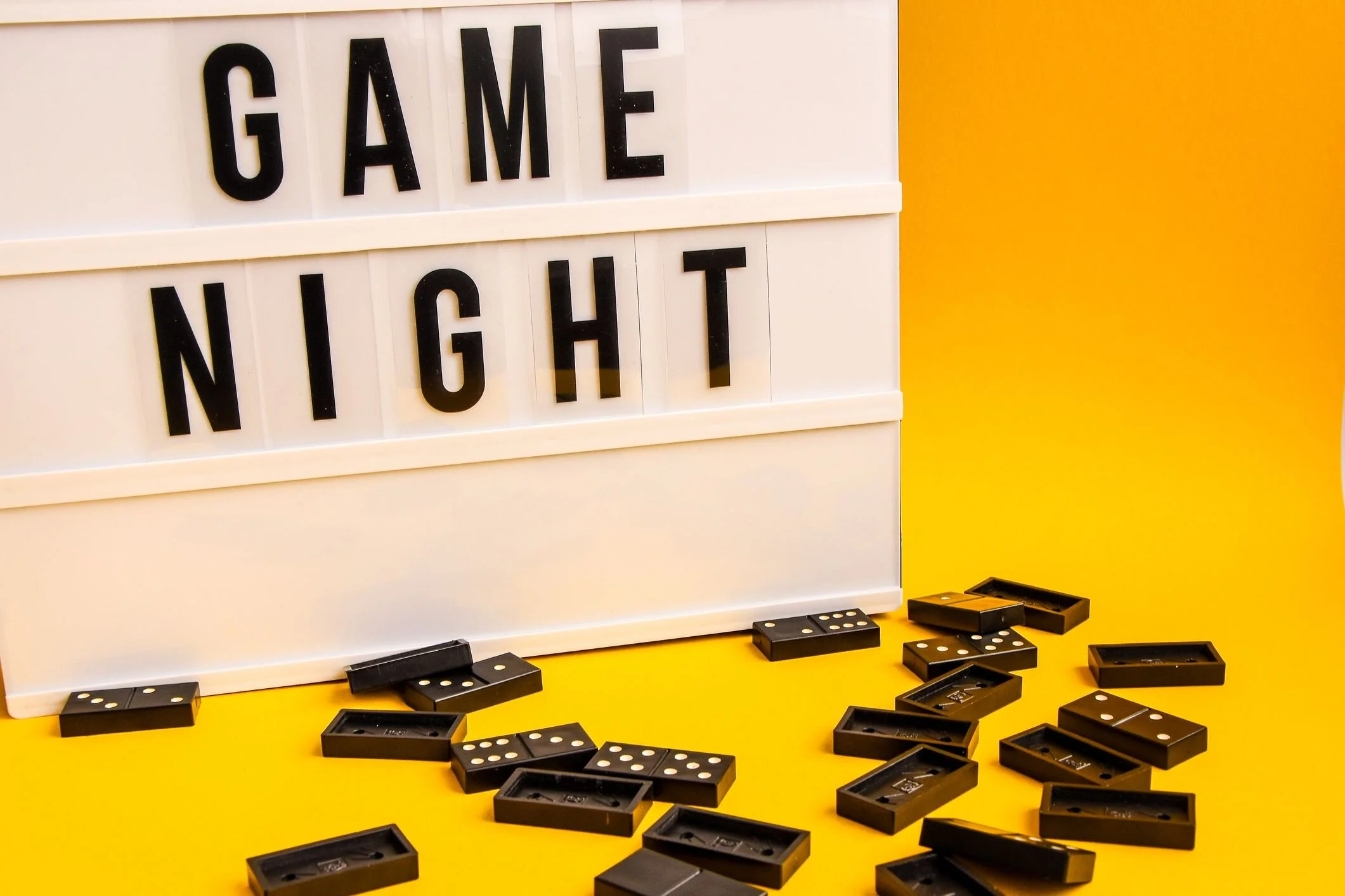 game-night-text-on-lightbox-with-black-dominoes-on-royalty-free-image-1585932331.jpg
