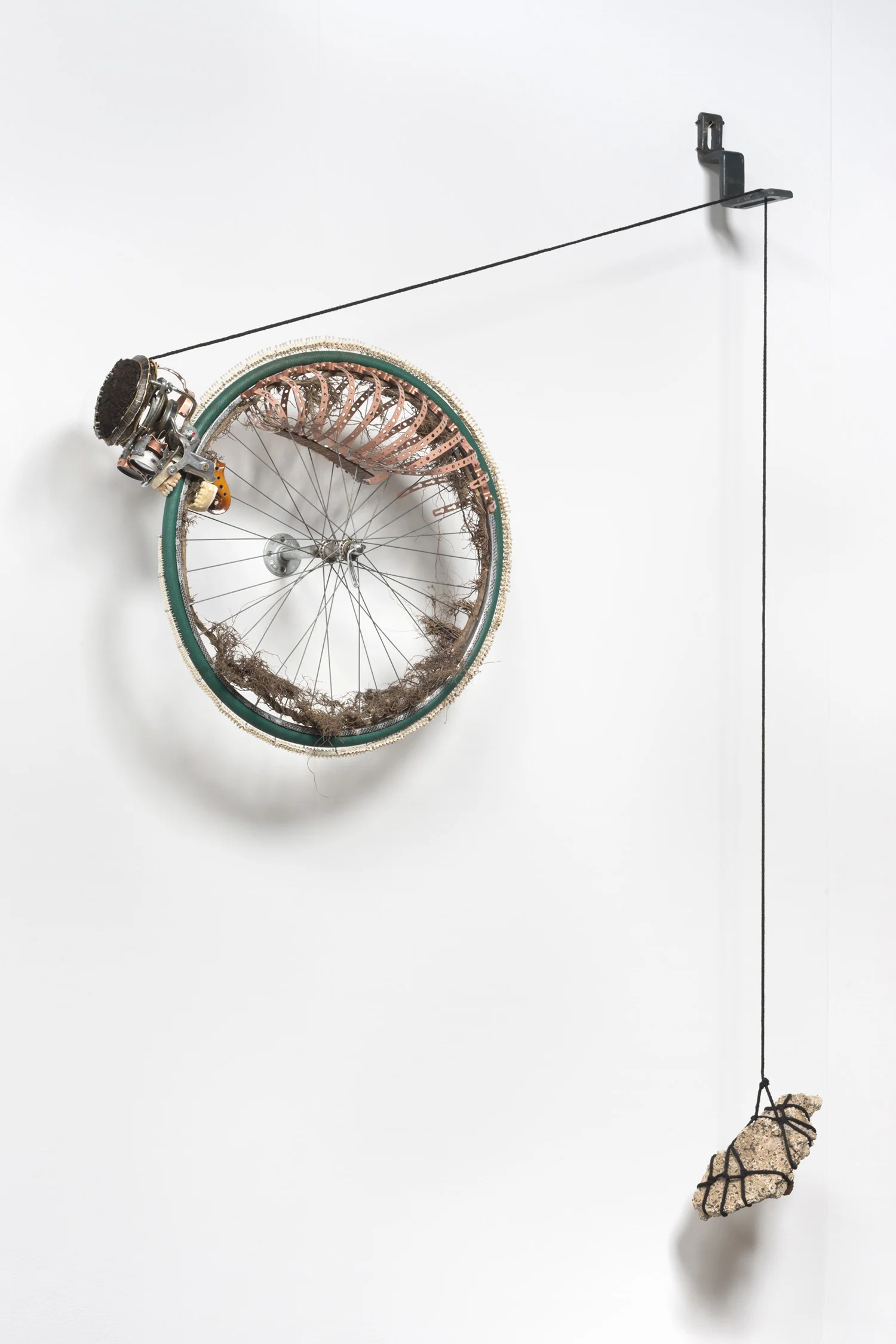 Lorna Williams-Ouroboros-2013-hair, plumbing hardware, violin parts, photography lenses, snake vertebrae, bike wheel, hose, ukulele neck, bike chain, plaster teeth, bike seat, speaker, snake shedding, root, rope, cement-88x60x13.jpg