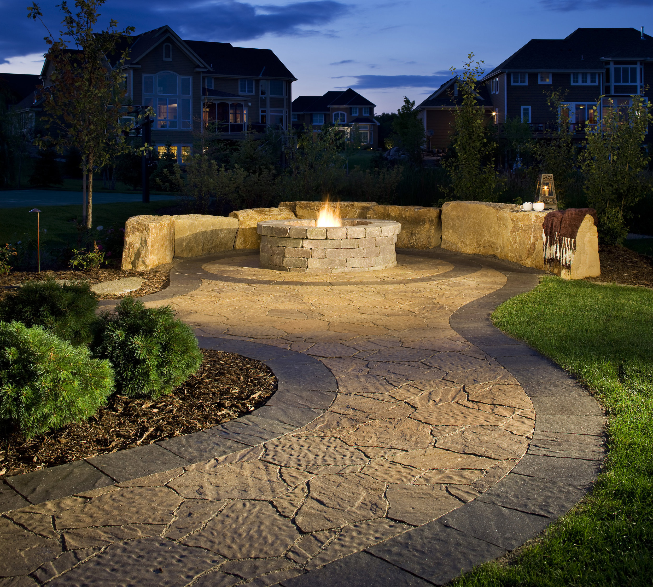 fire pit sitting wall patio natural stone pavers smores plants landscape lighting relax