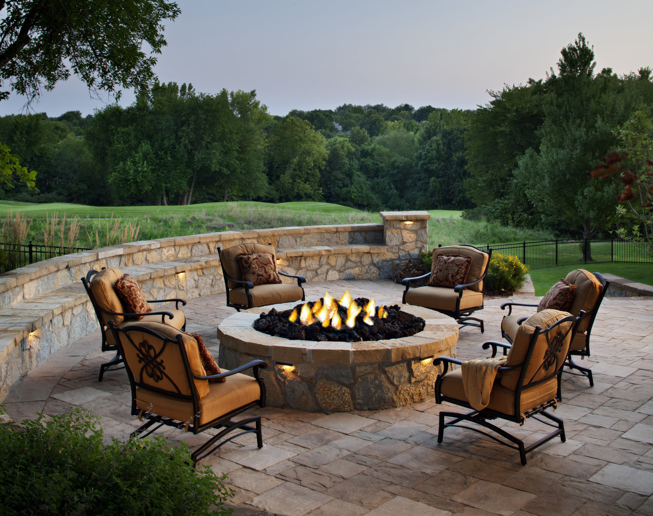fire pit sitting wall landscape lights patio green grass landscape