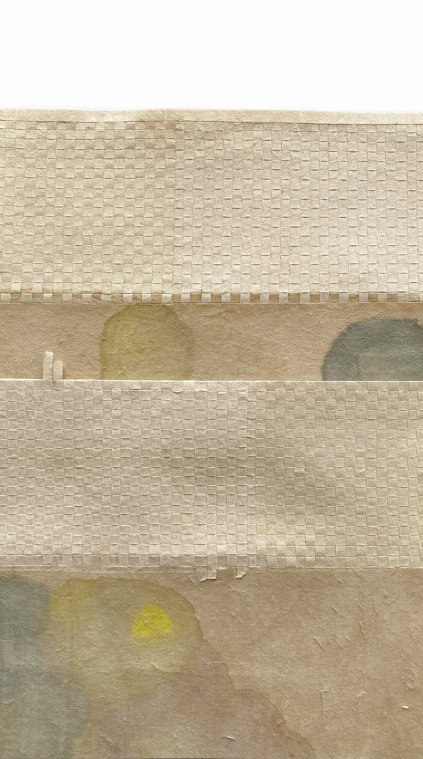 handmade paper weaving with pastel pink, yellow, and green watercolor