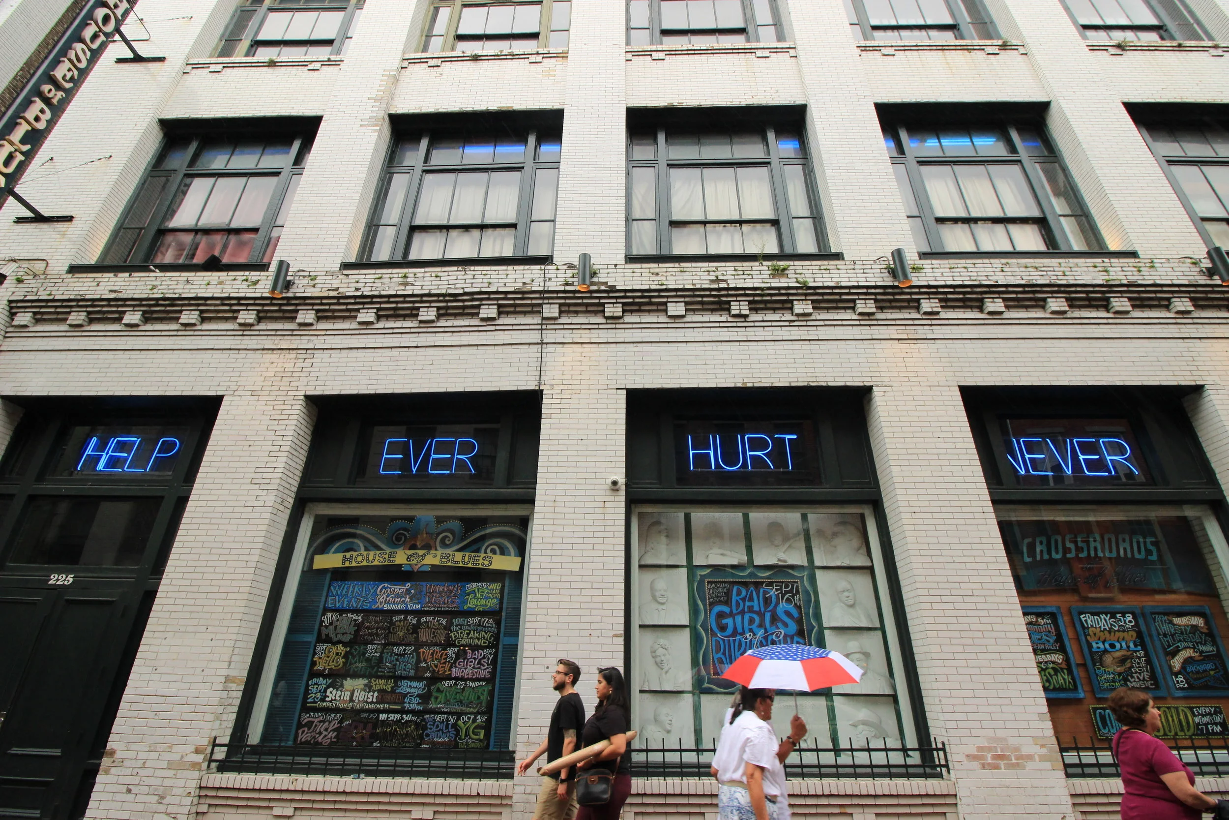 Neon signs adorn a storefront in New Orleans.