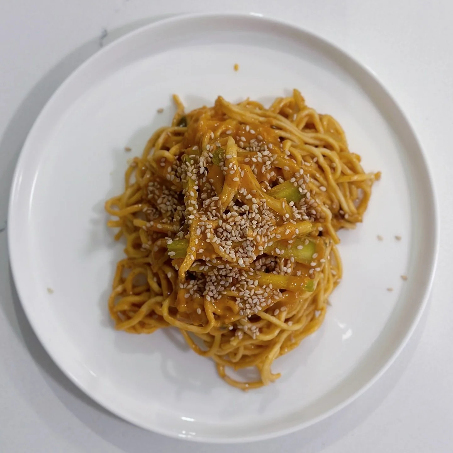 Chewy noodles coated in creamy peanut sauce, balanced with a hit of lime and crunch.