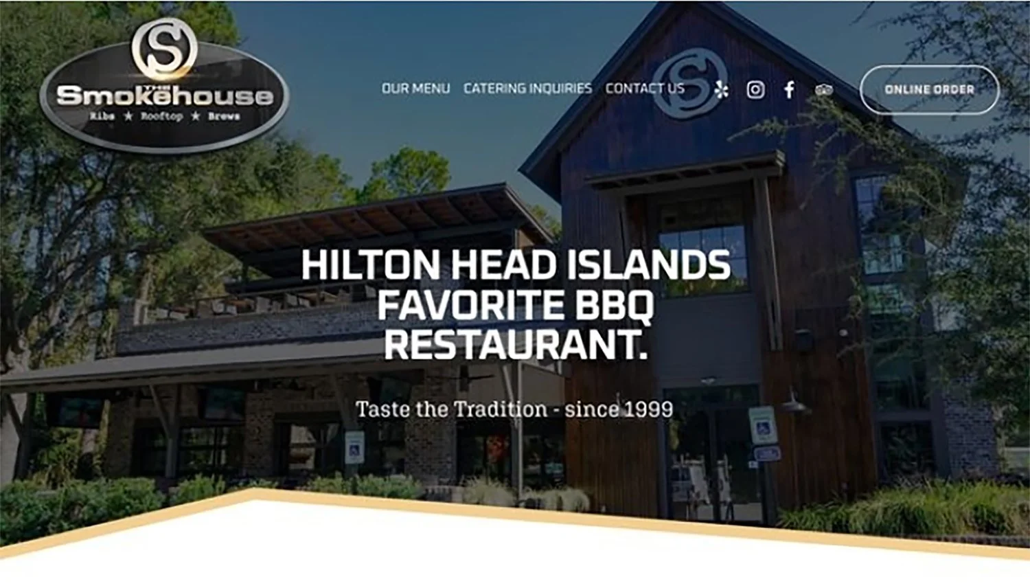 Exterior view of Hilton Head Islands Smokehouse restaurant, a rustic building with a wooden facade and a rooftop patio, surrounded by trees, signage indicating 'Smokhouse' and menu options at the top.